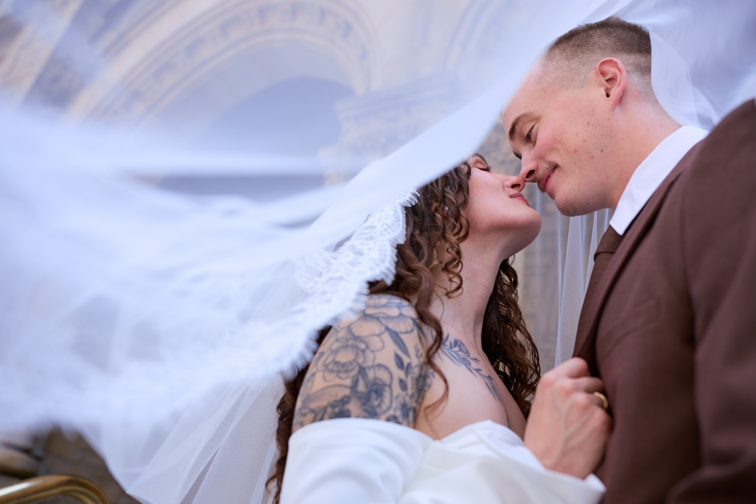  Kiss beneath a flowing veil in front of historic arches, Columbus Ohio