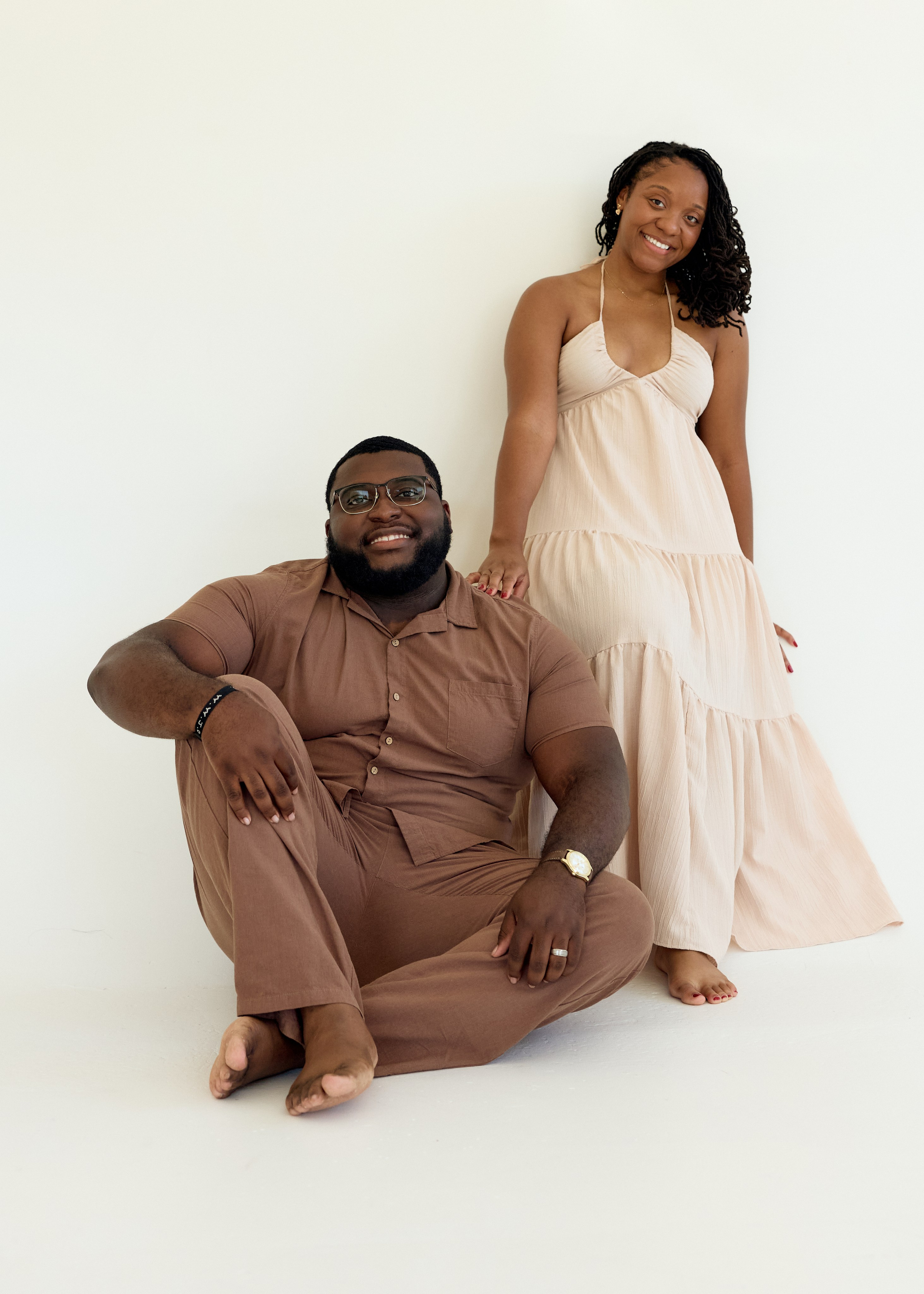 Casual pose with him on the floor beside her, Columbus studio engagement shoot