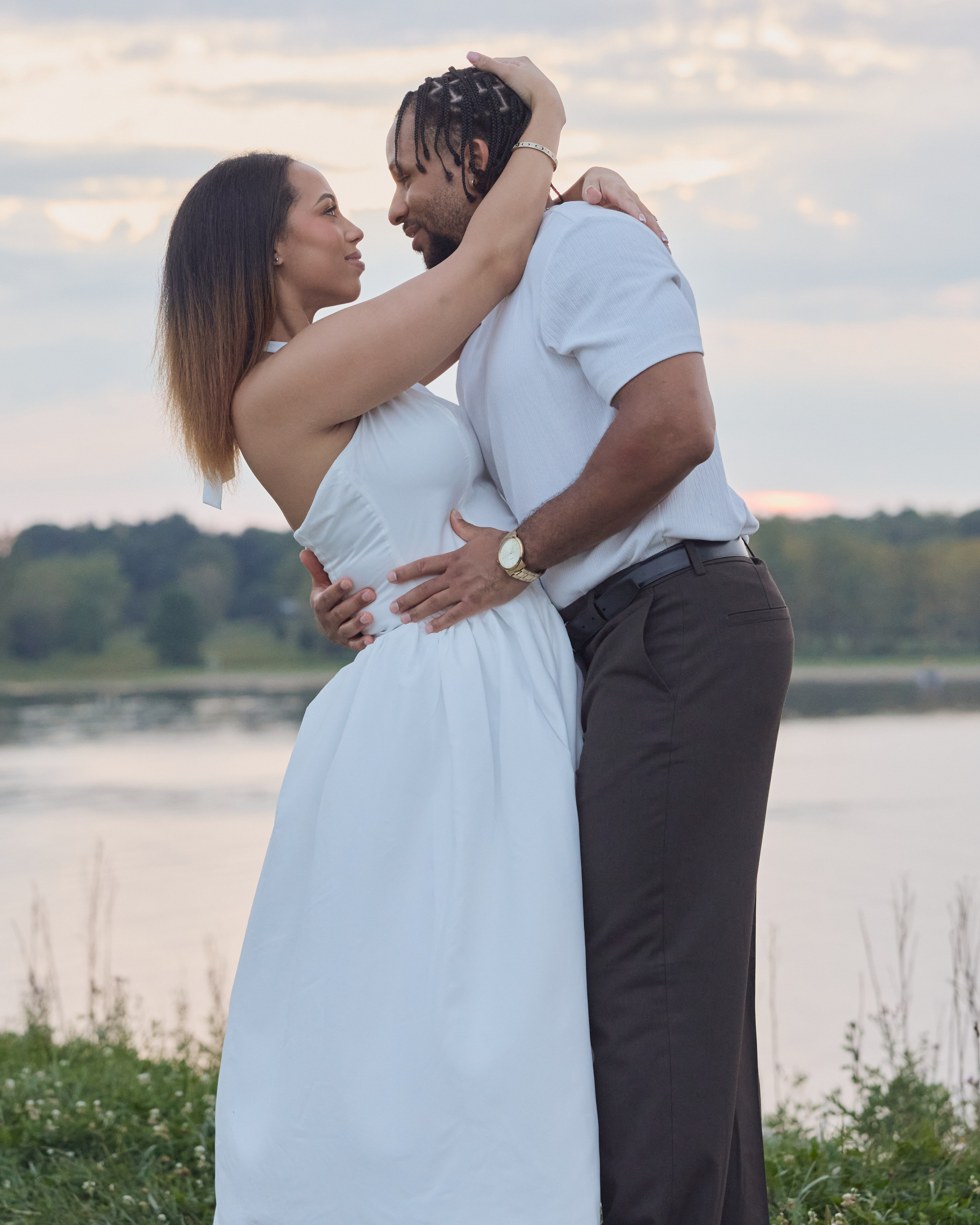 Sunset embrace by the water during an engagement session at Alum Creek, Ohio