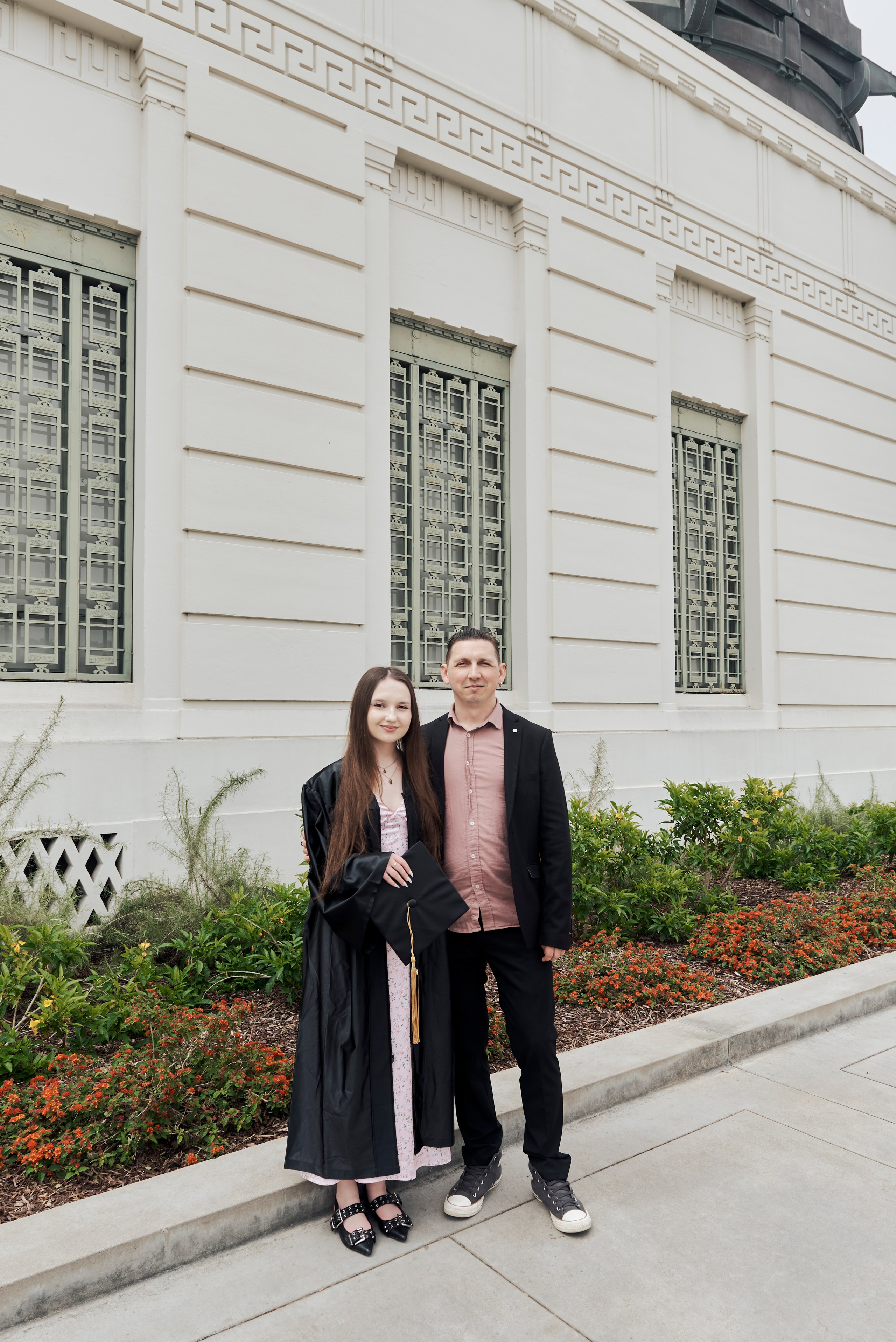 Portrait of a graduate in cap and gown at a famous Los Angeles theater