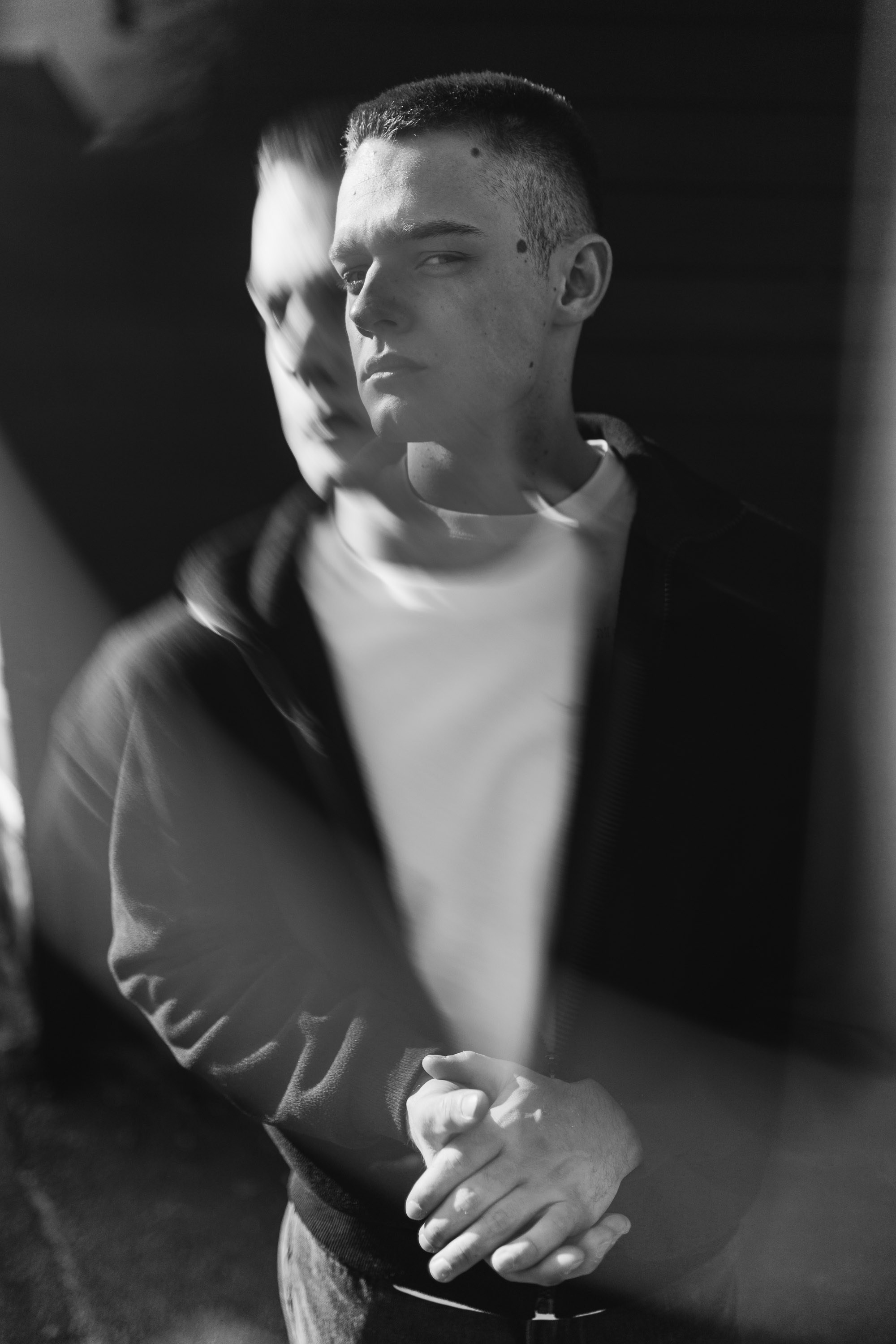 Black-and-white portrait of man smiling with motion blur