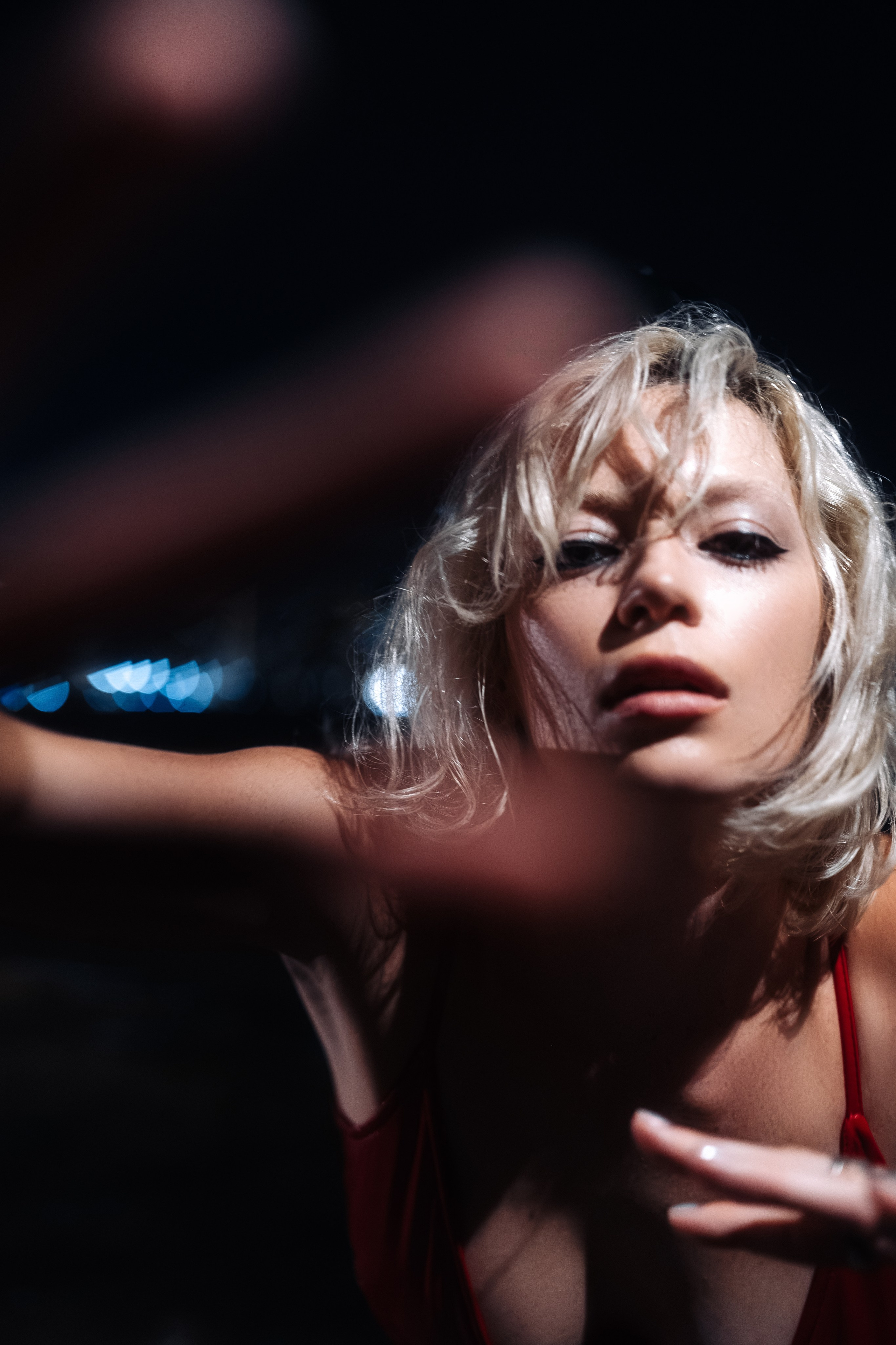 Portrait emphasizing the face and collarbone, lighting introduces sculpted depth. Professionally graded