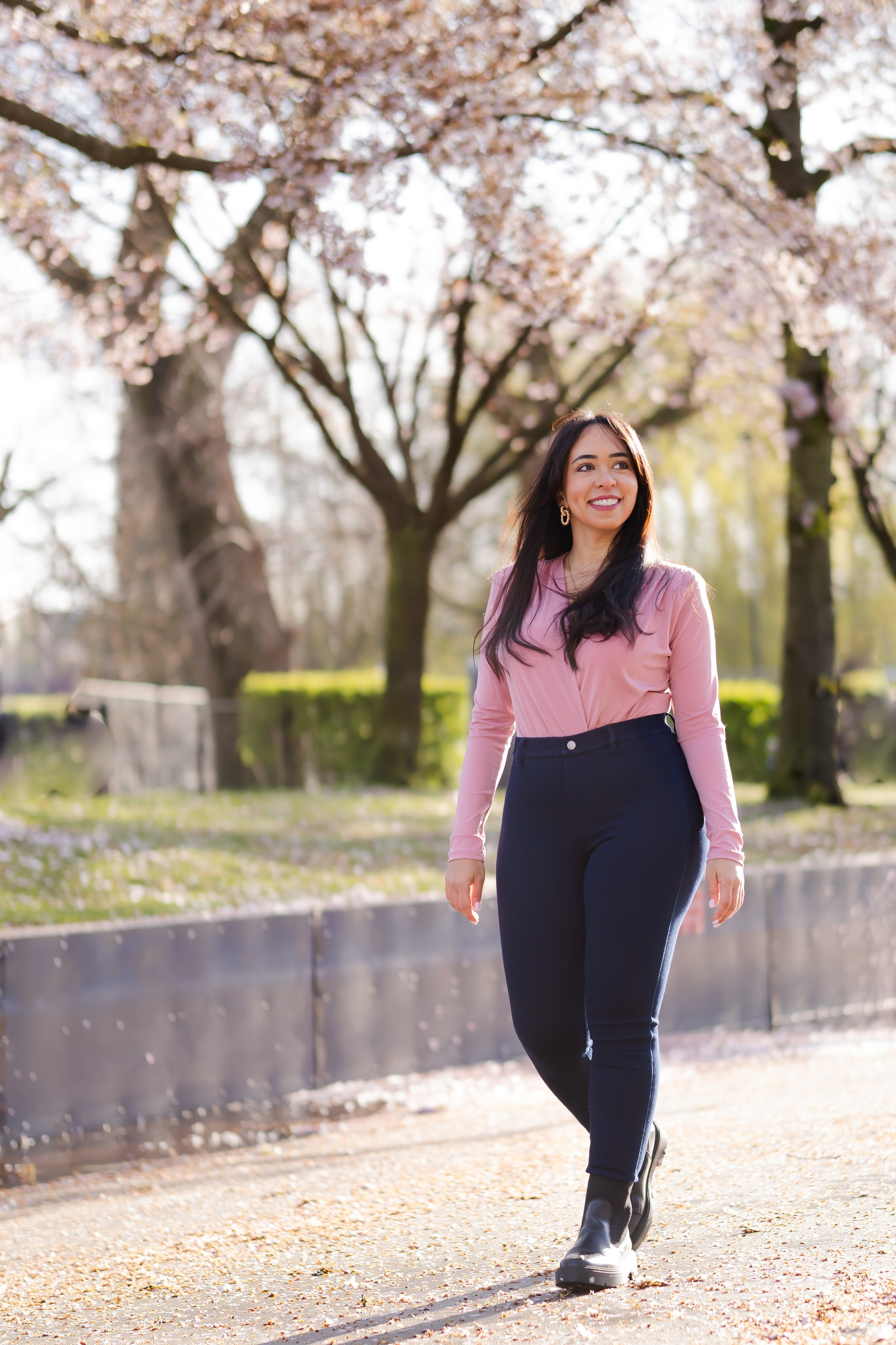 girl walking in a cherry blossoms garden in Amsterdam