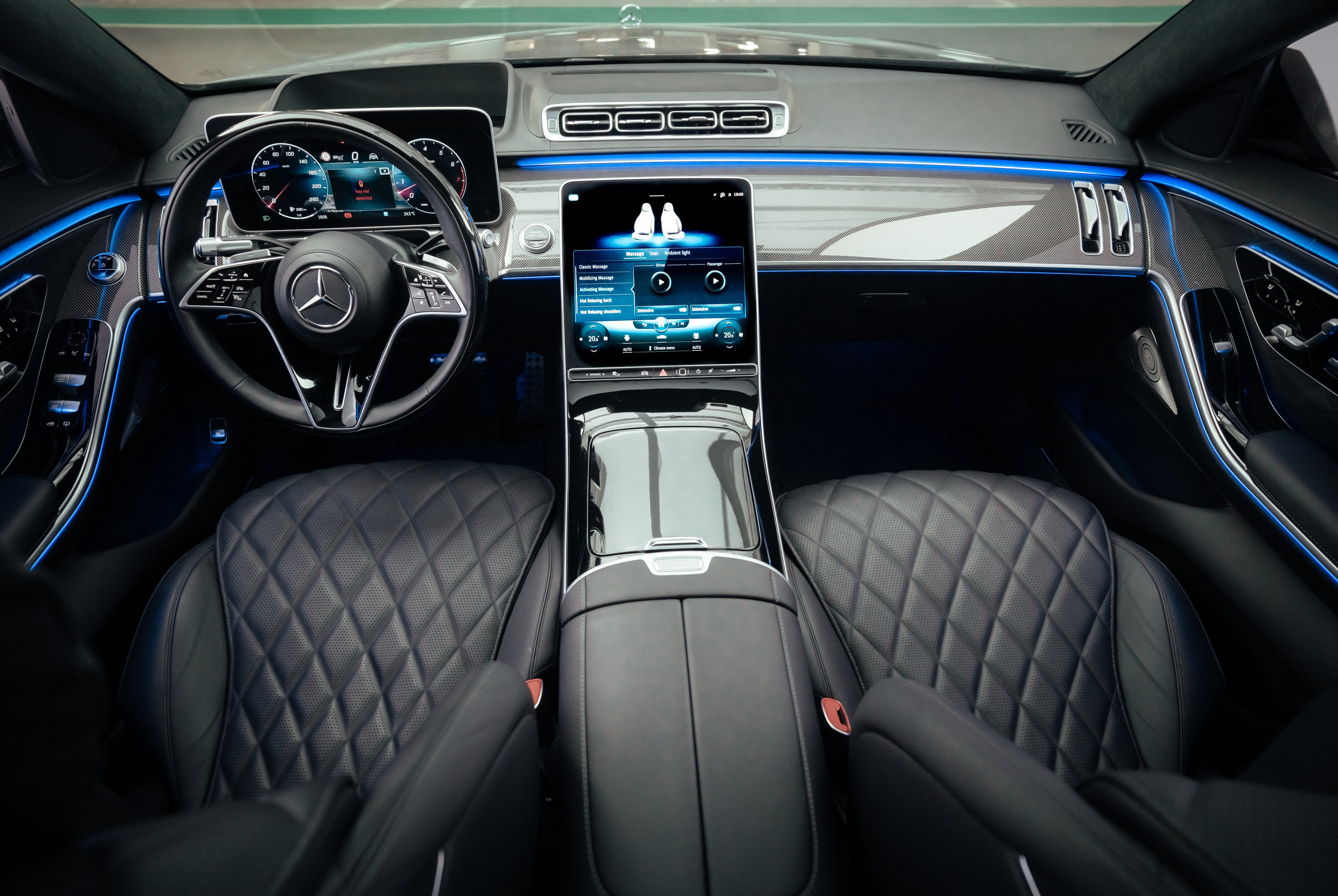 The control panel of the Mercedes rear seat is dark in color with neon carbon fiber coating