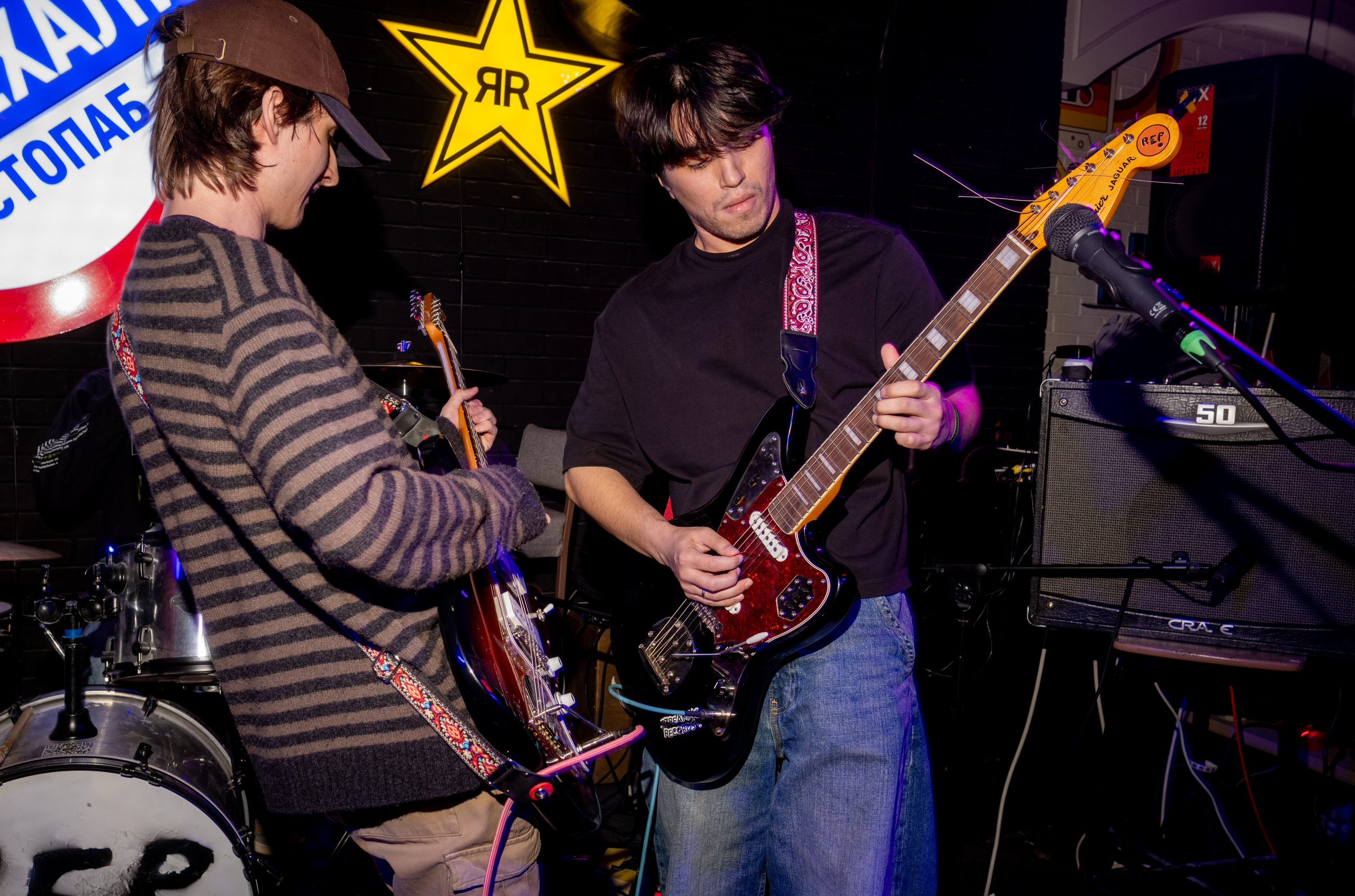elbowsway: guitarists in striped sweaters playing on stage — Boshqa Musiqa Fest, Ponaexali Hall, Tashkent, September 2026