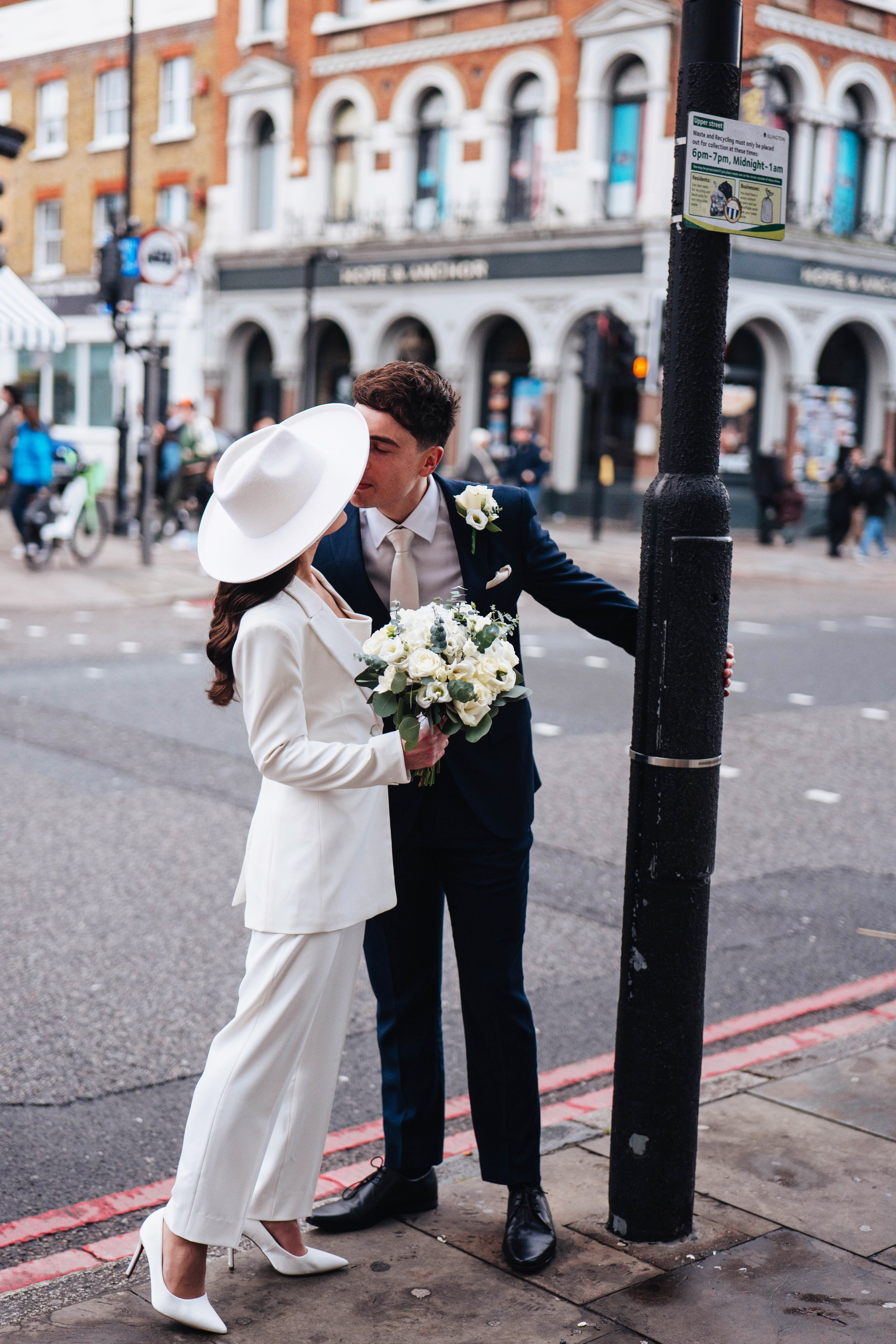 Stylish wedding in Islington, white women costume and white hat