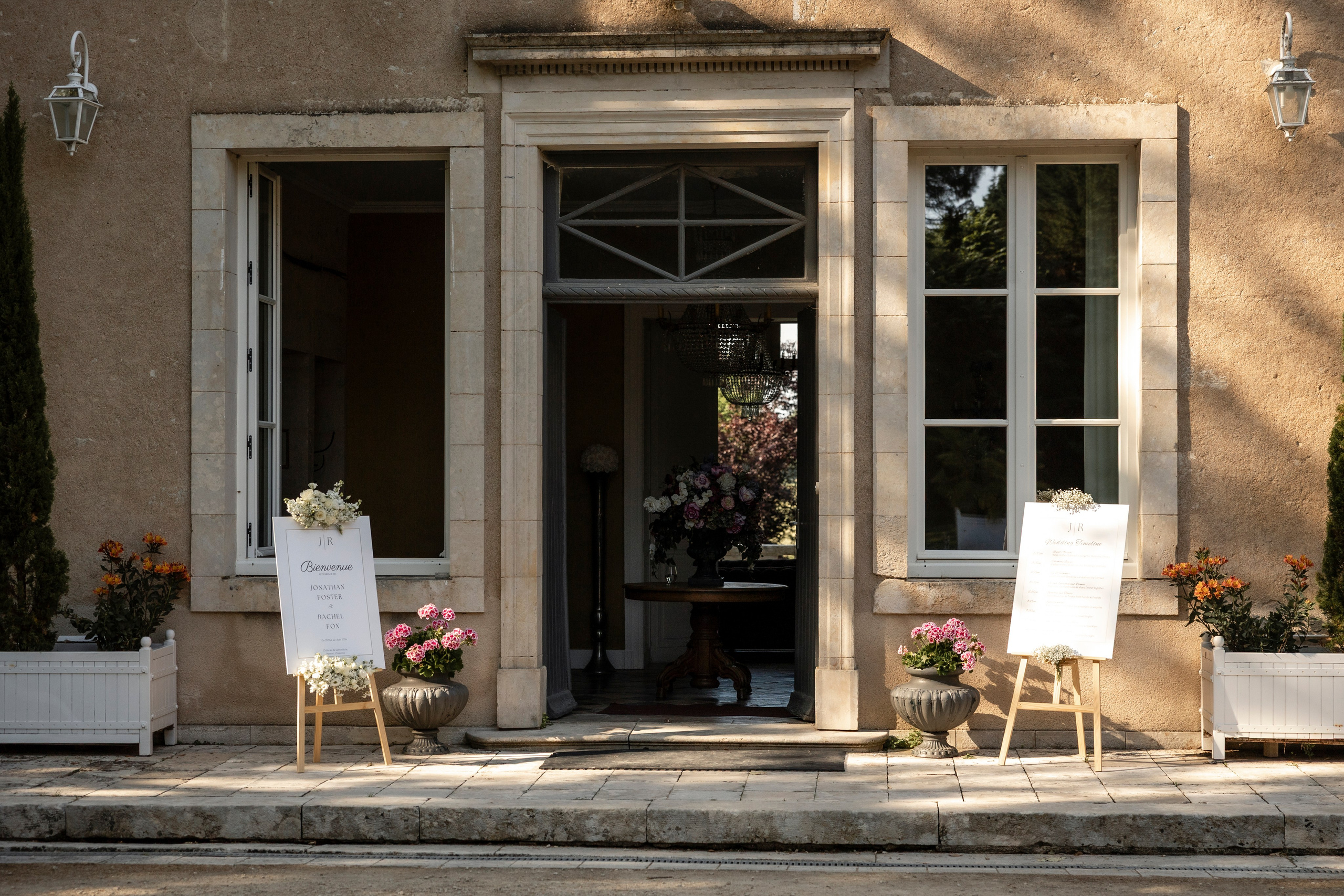 French doors of the château with chairs and welcome signs set out for arriving guests