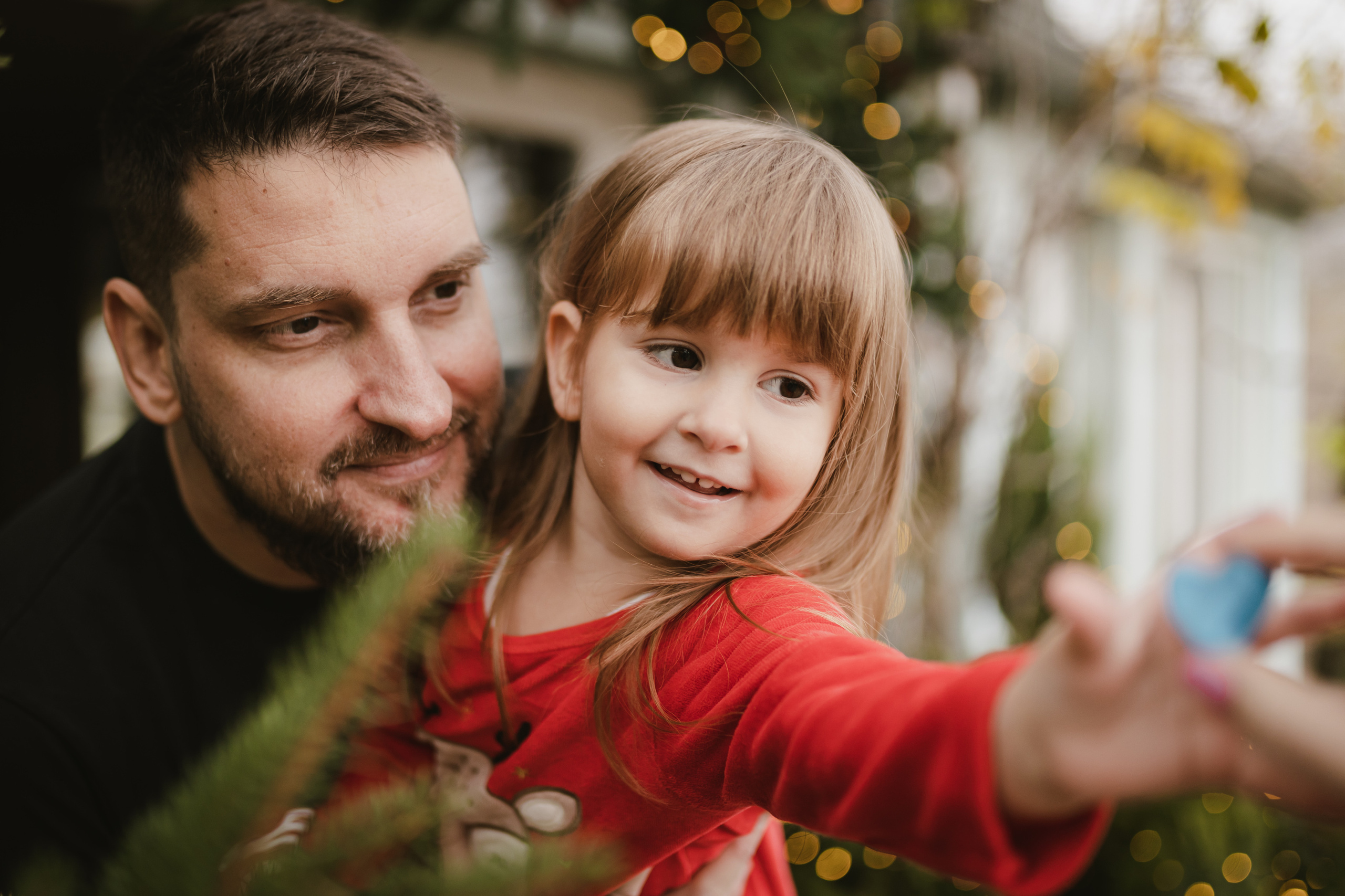 Porodična slika sa novogodišnjim dekoracijama u studiju.