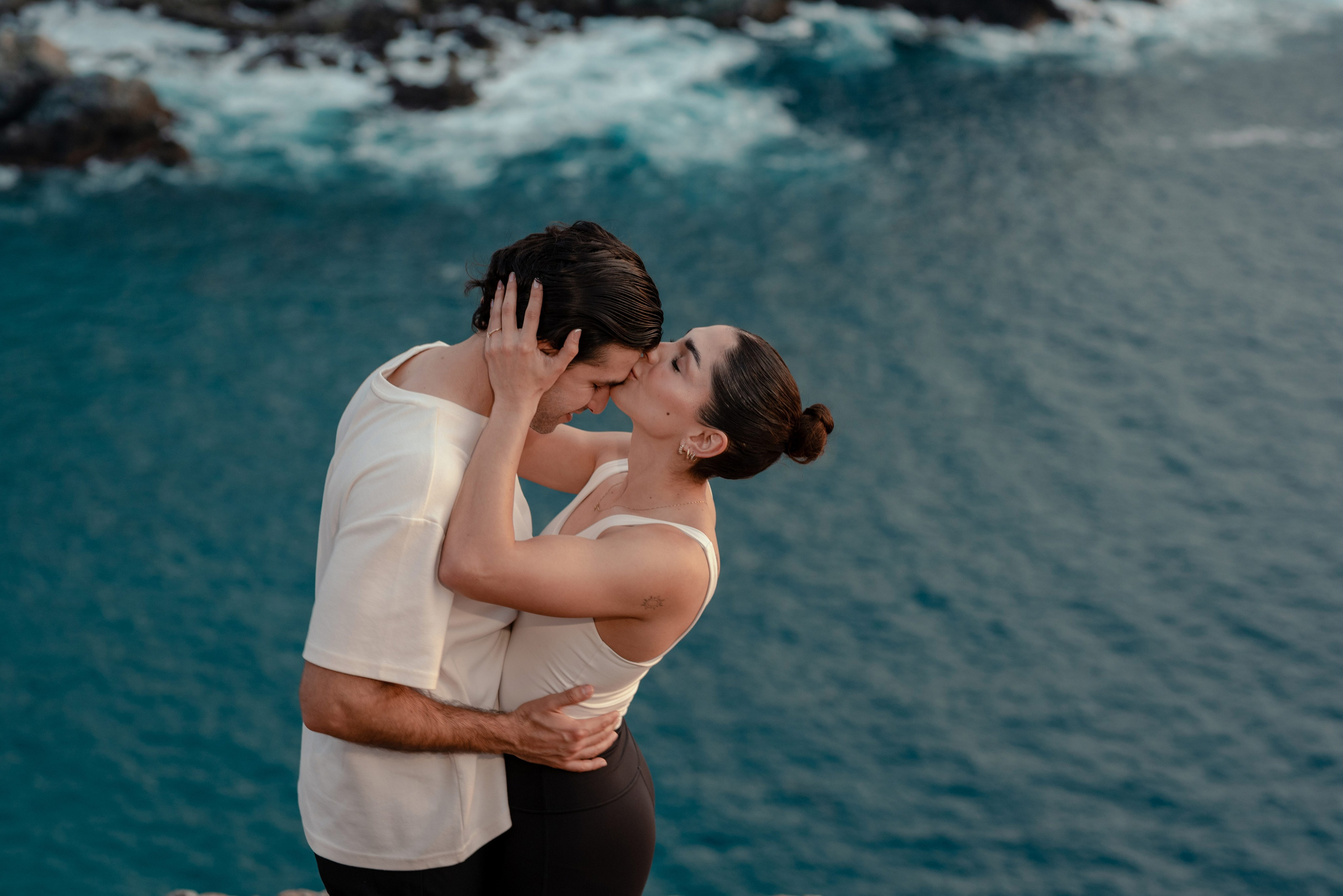 couple on their special and intimate moment,at todos Santos, with the ocean background