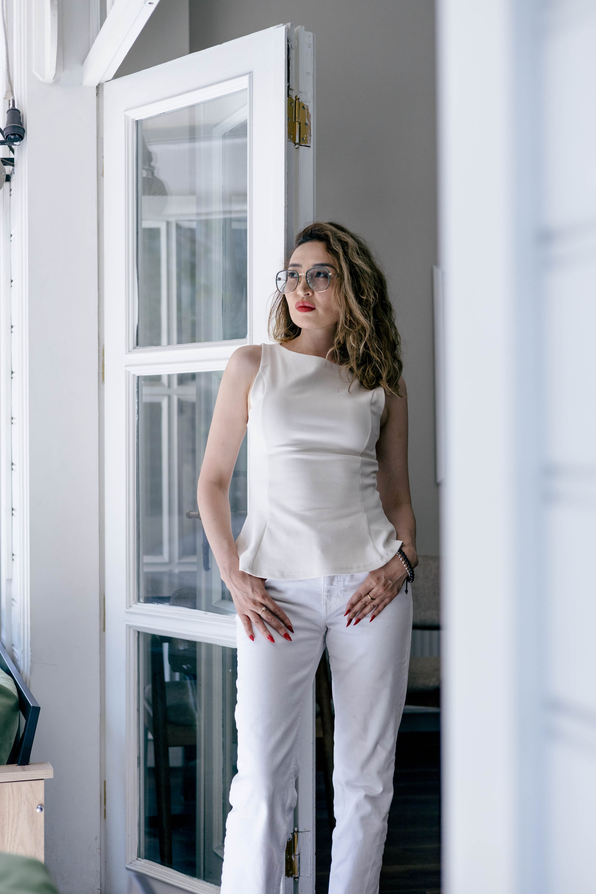 Full-length portrait of a woman standing by a doorway