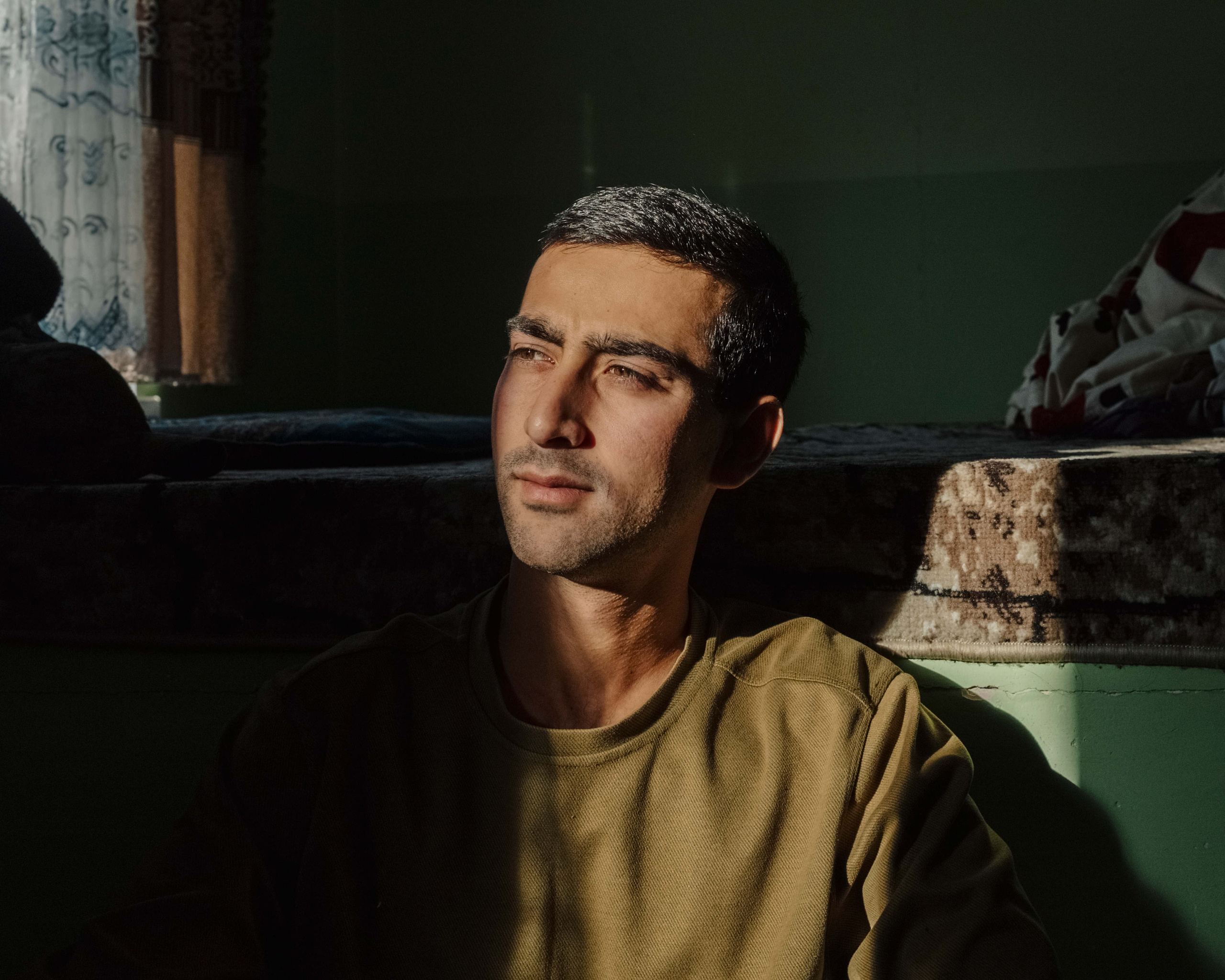 Behruz, 22, at his home in Dushanbe, Tajikistan. He was the top entrant to Ufa University of Science and Technology in Russia before being arrested on suspicion of involvement in a rape and murder case near the campus, a case later dropped for lack of evidence. He was released after a month in detention and deported, barred from returning to Russia for five years. After serving two years in the army, he now works as a waiter while hoping to study abroad. “I still might go to Russia, but I don’t know,” he said.