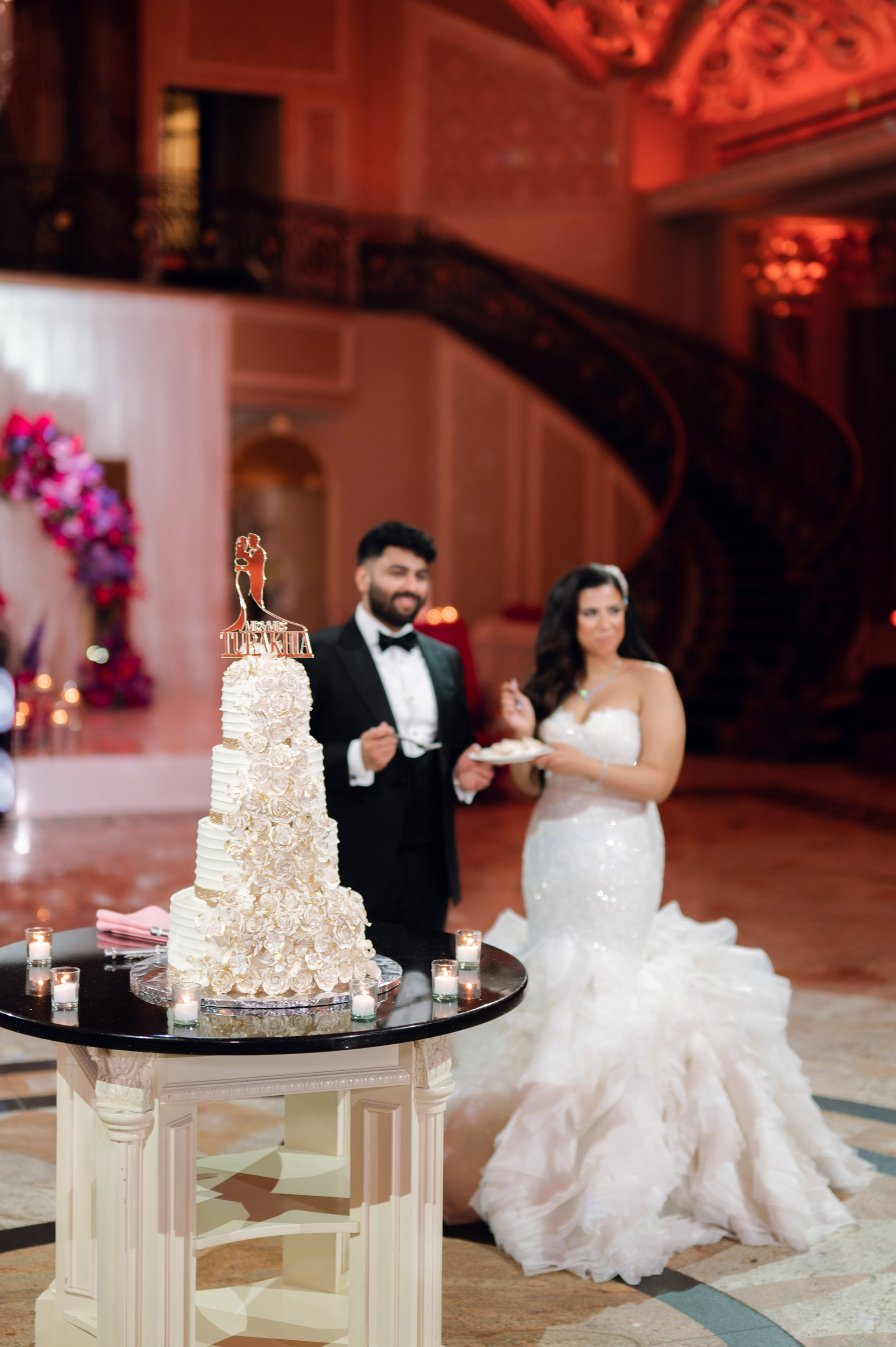 a bride and groom are cutting their wedding cake