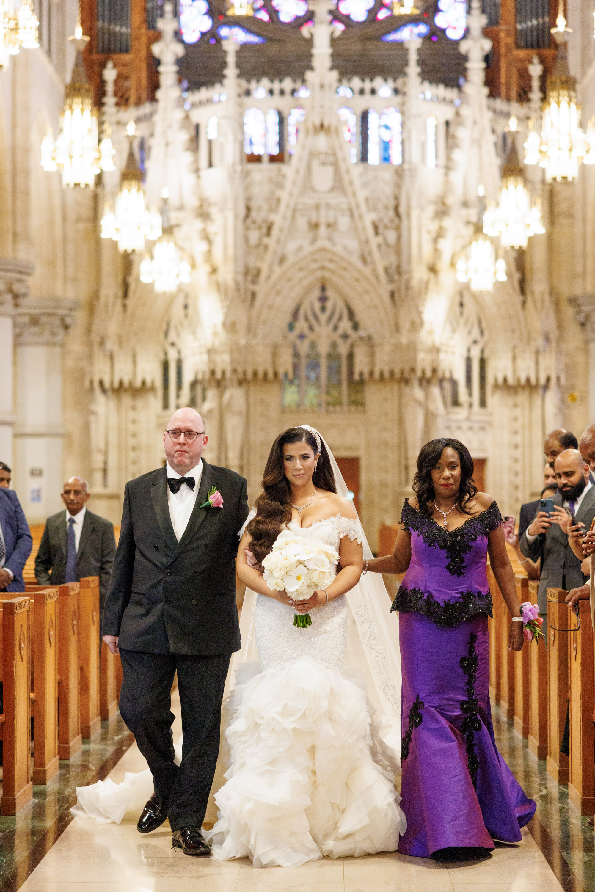 a bride and groom walking down the aisle