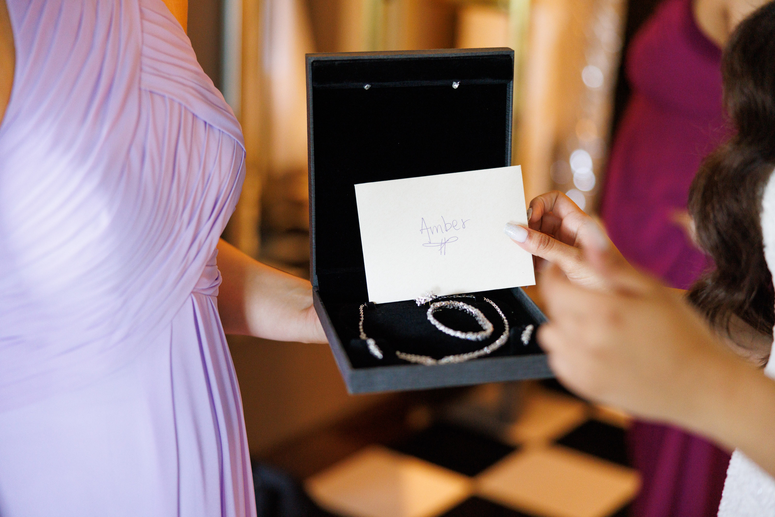 a woman holding a ring in a box