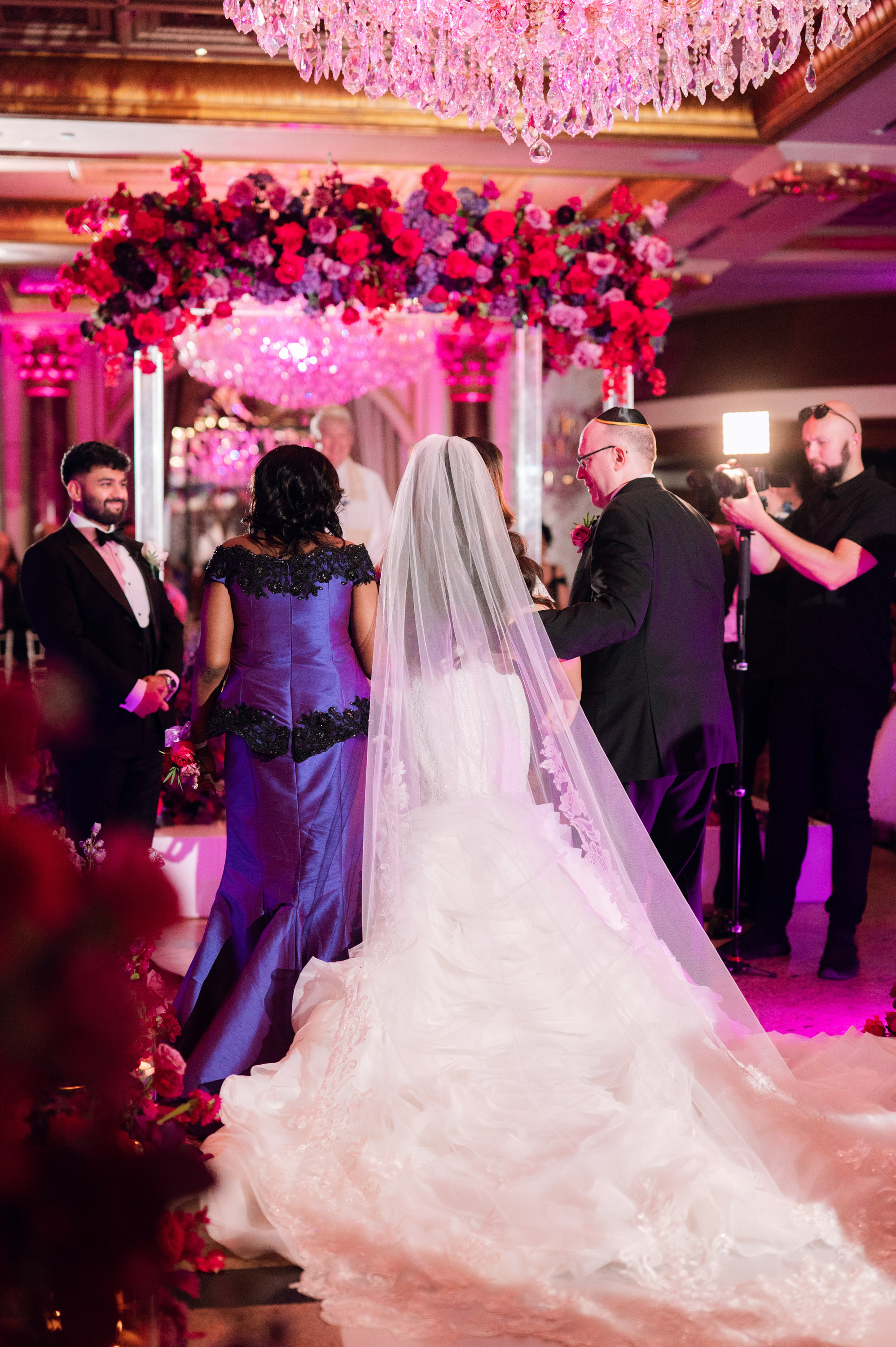 a bride and groom walking down the aisle