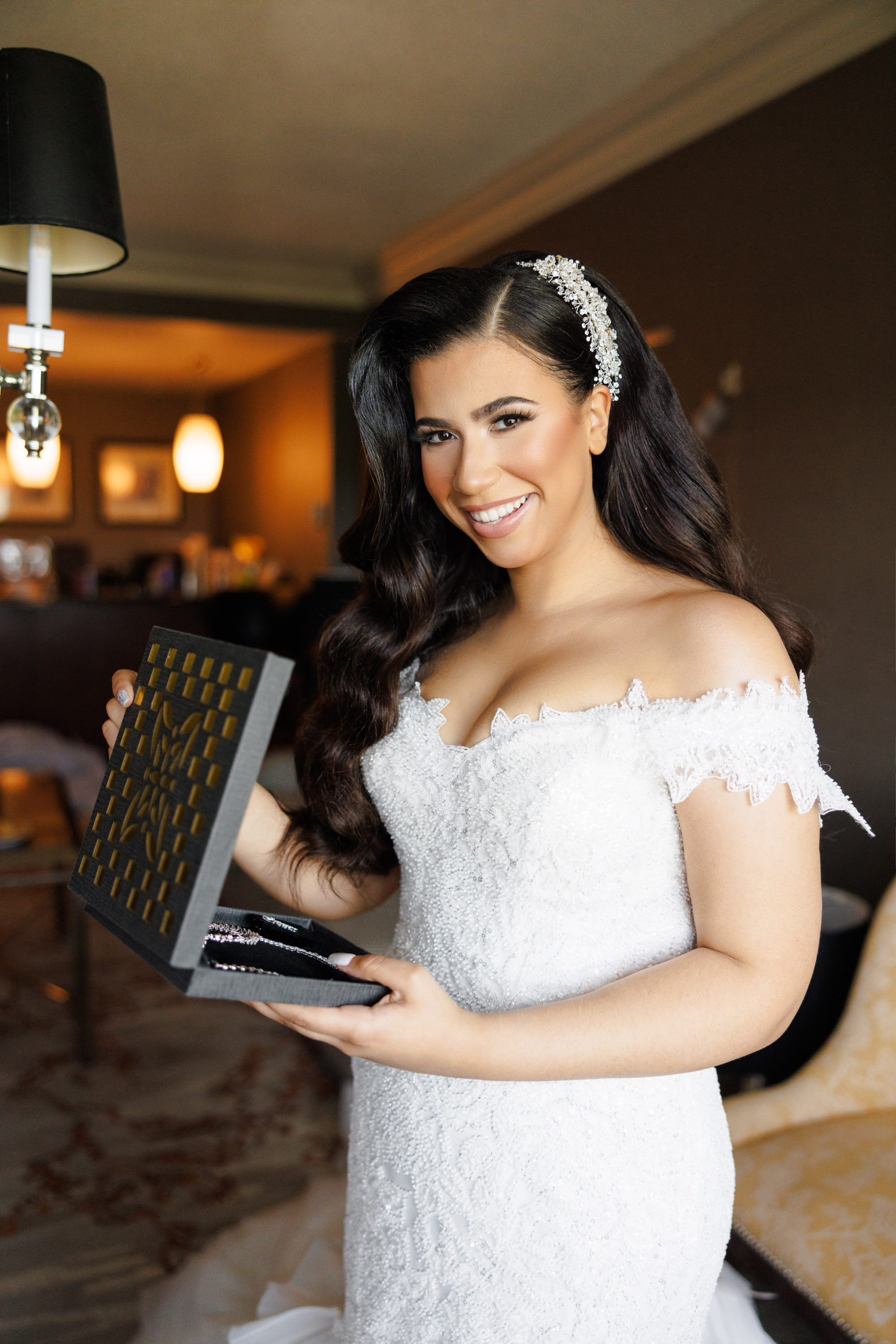 a woman in a wedding dress holding a box