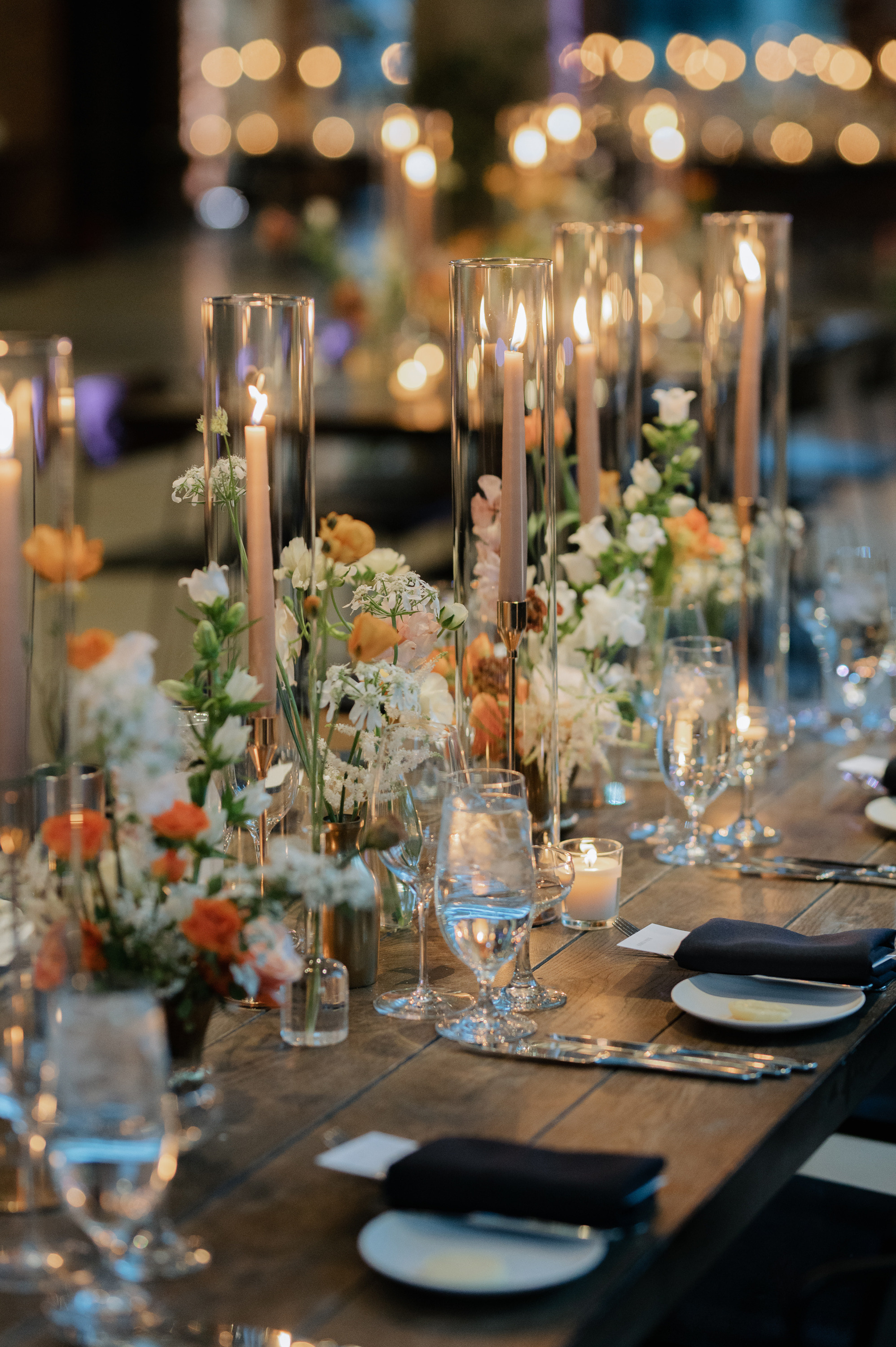 a table with a bunch of flowers and candles
