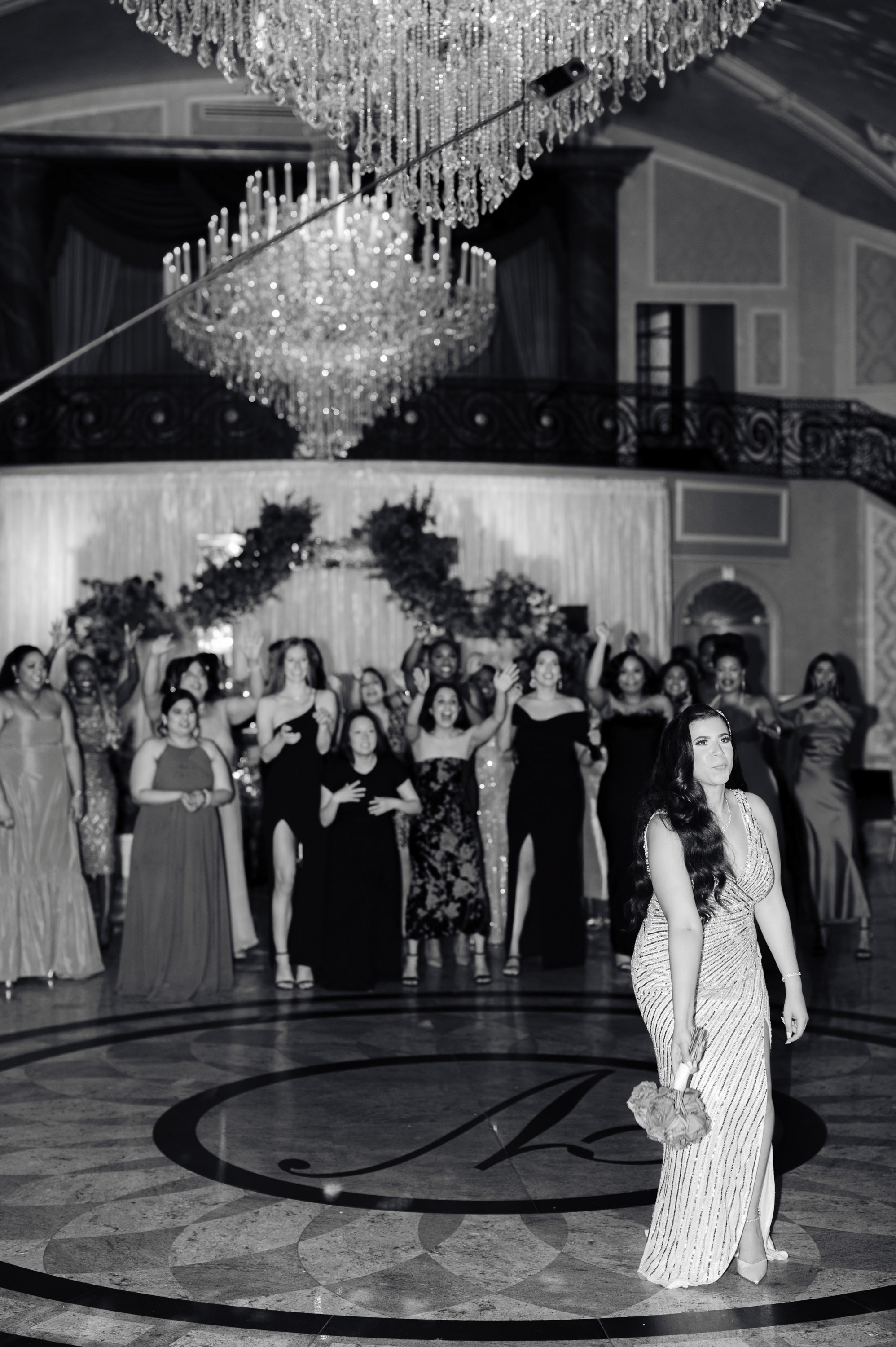 a bride and groom dance in the ballroom at their wedding