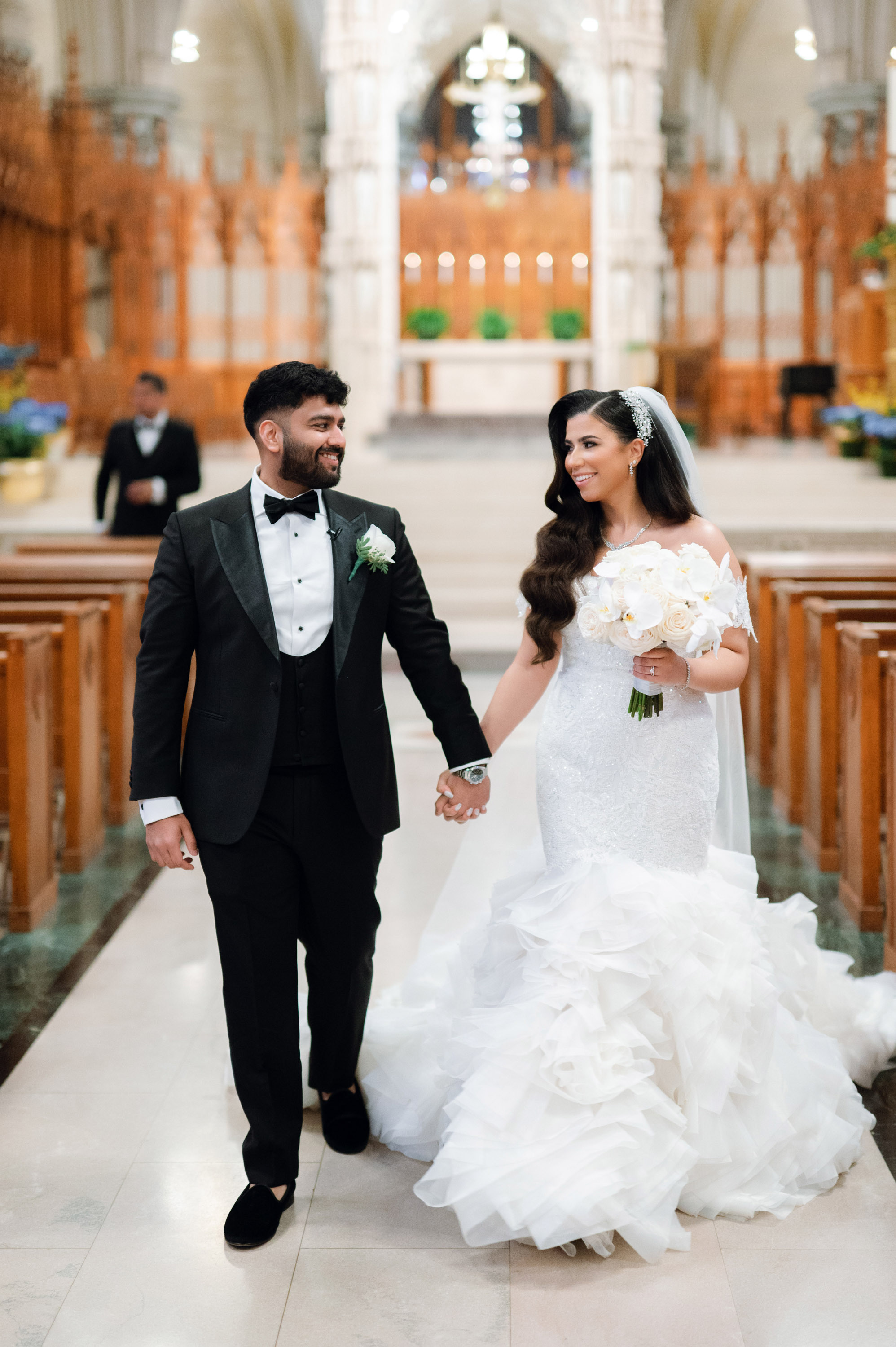 a bride and groom walking down the aisle