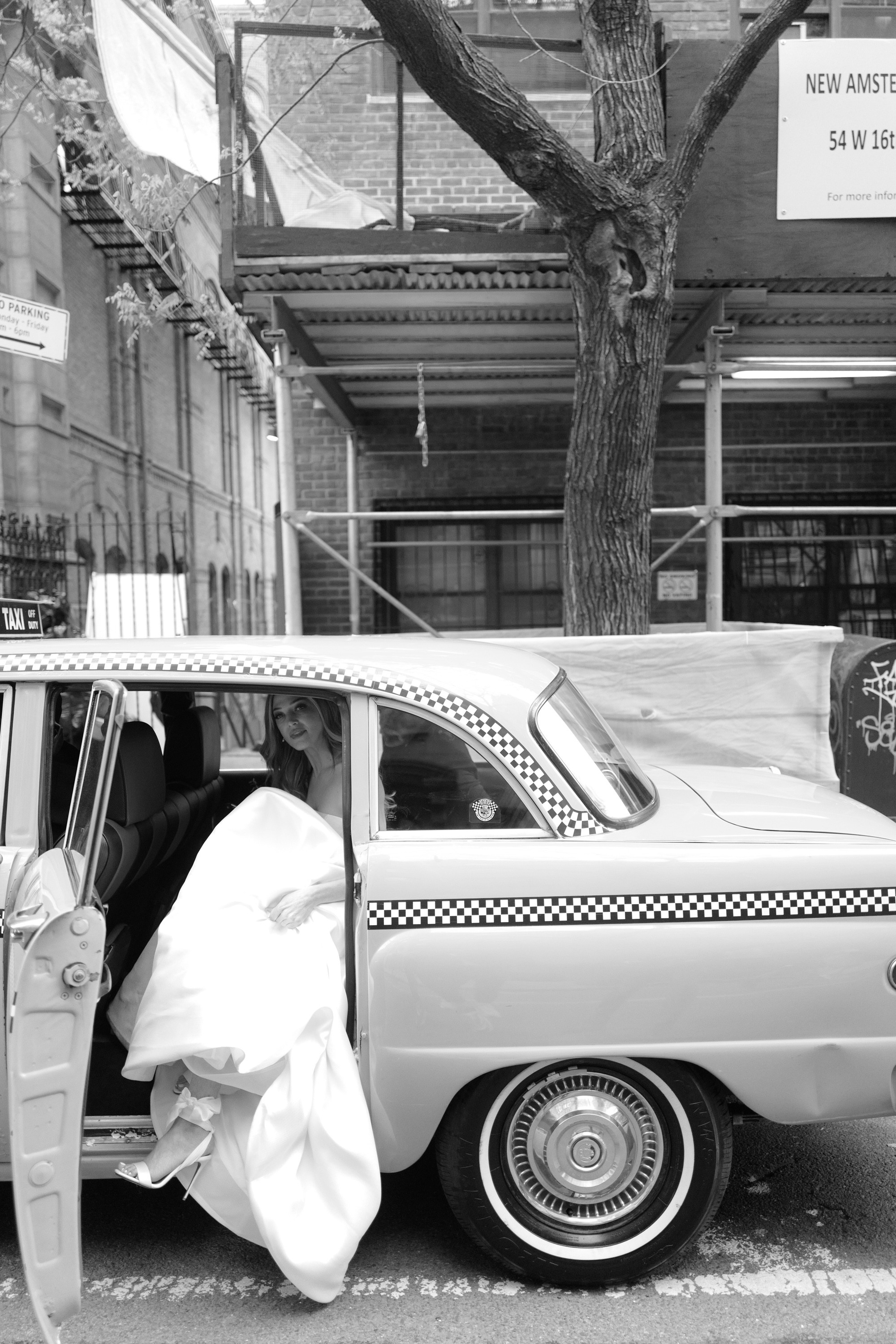a man standing next to a car with a bag on it