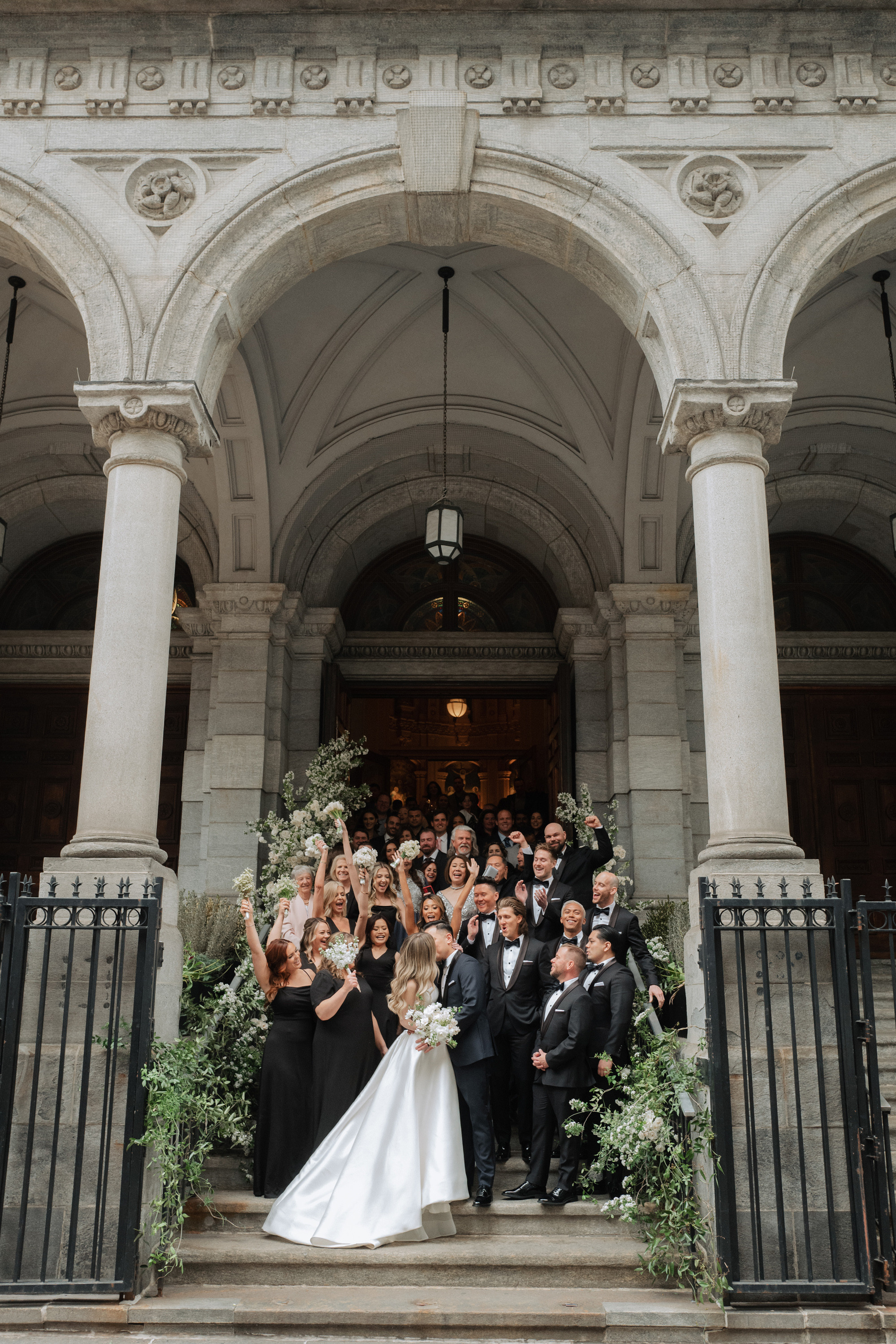 a group of people posing on the steps of a building