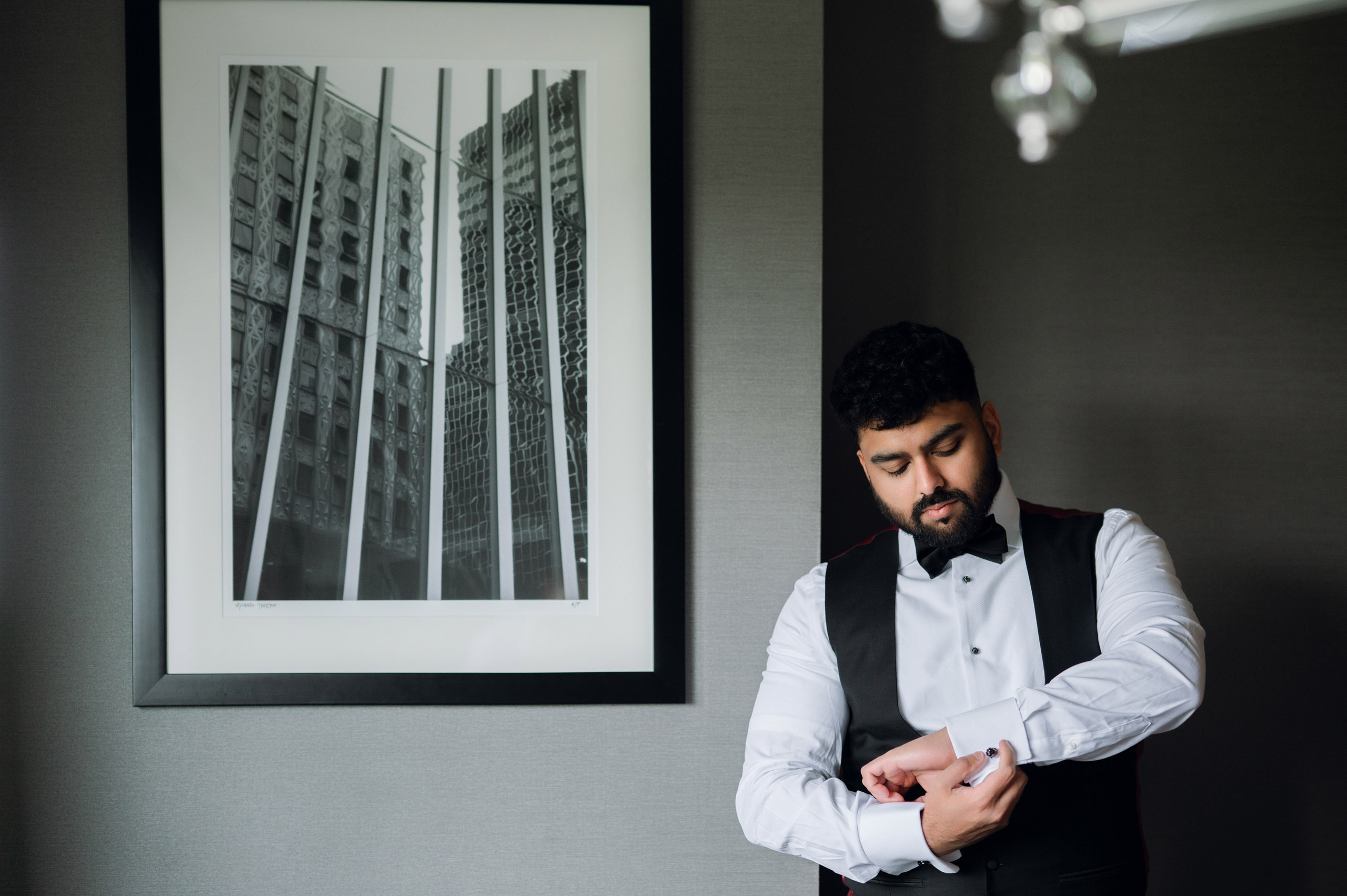 a man in a white shirt and black vest