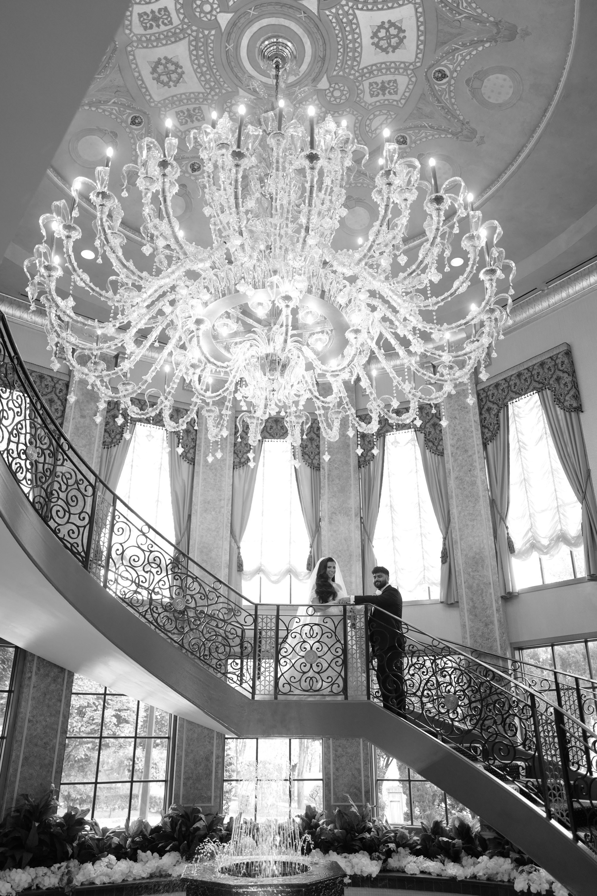 a bride stands on the stairs of a staircase