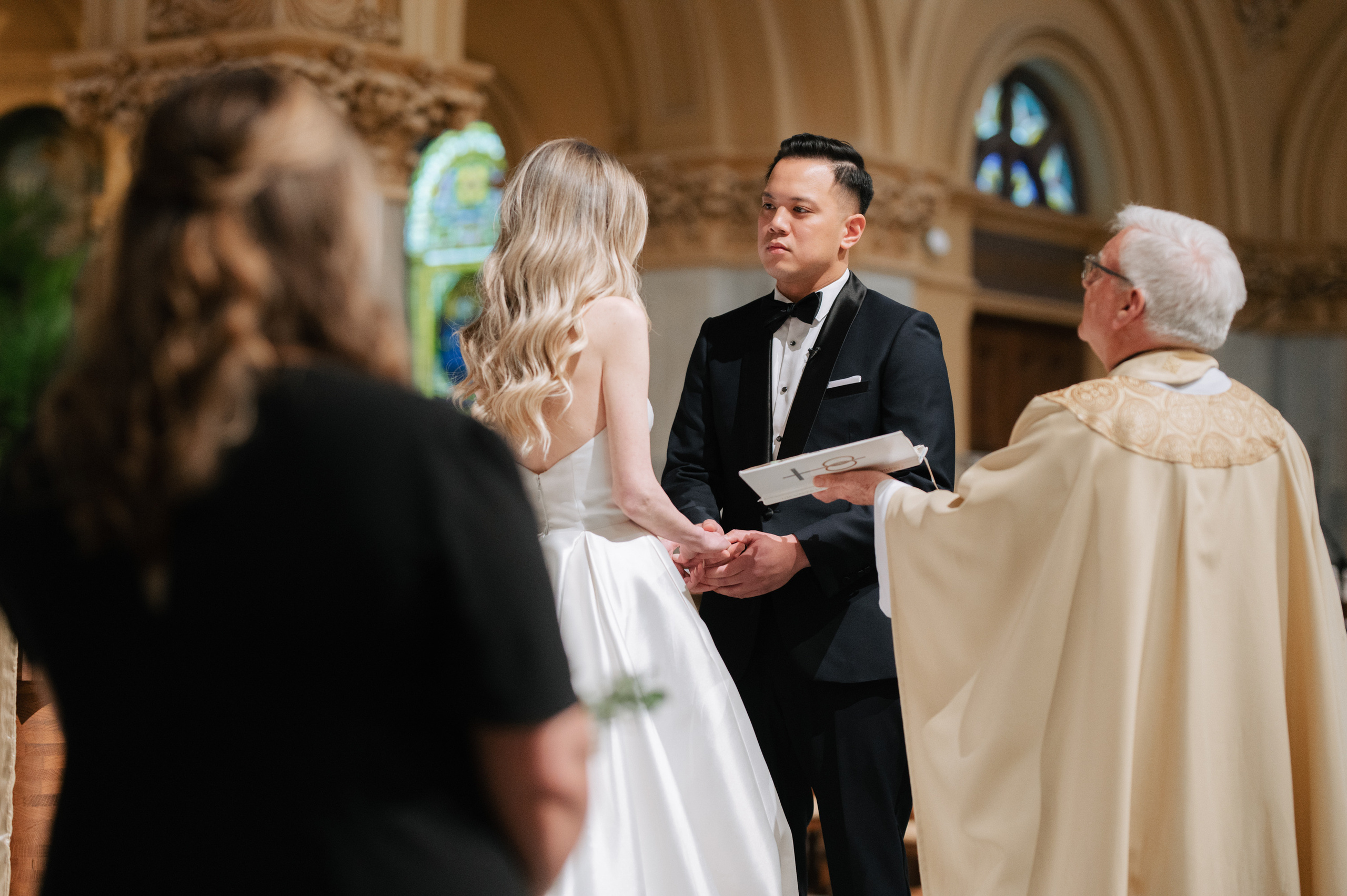a man and woman are standing in a church