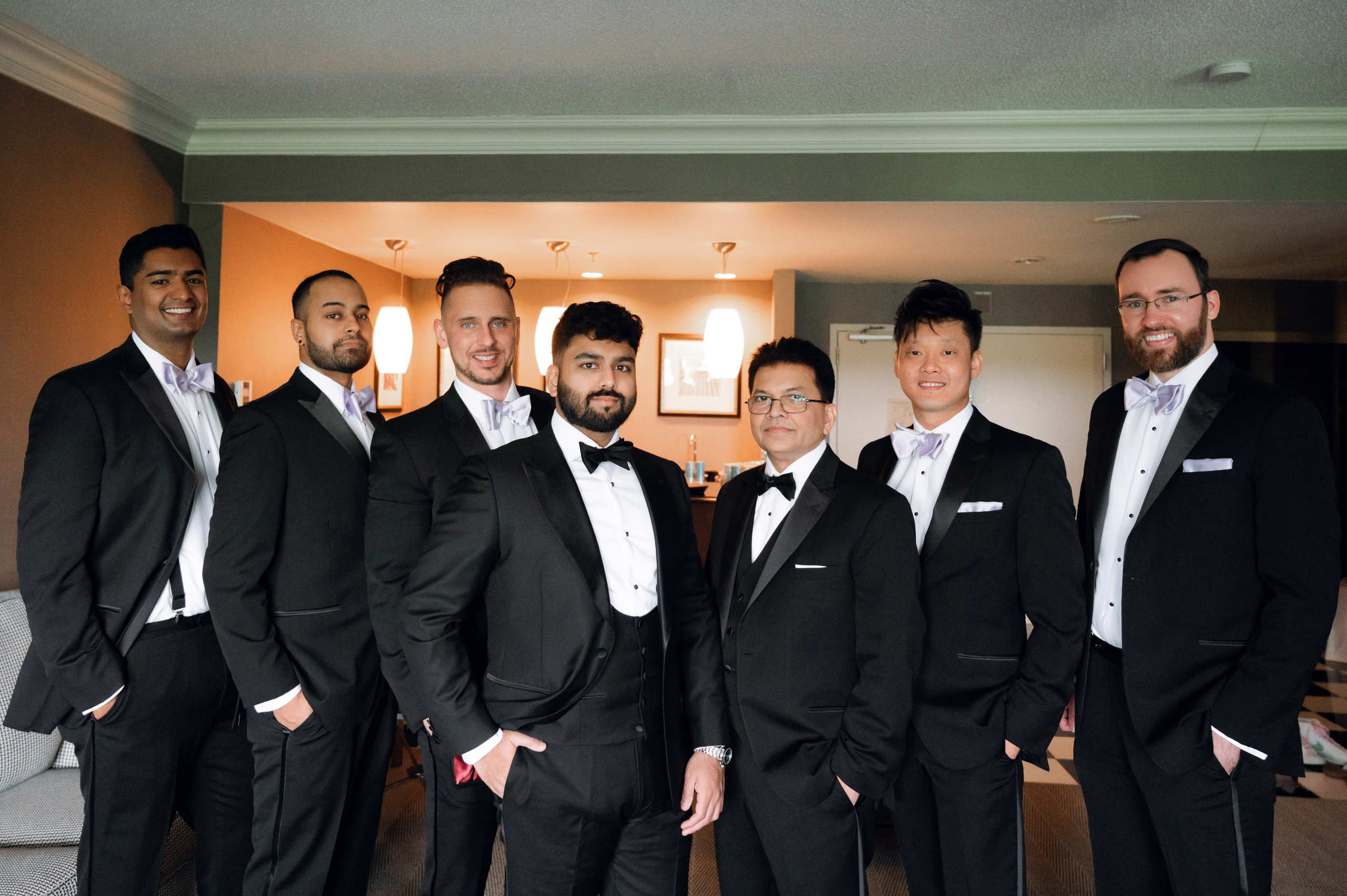 a group of men in tuxed suits posing for a picture