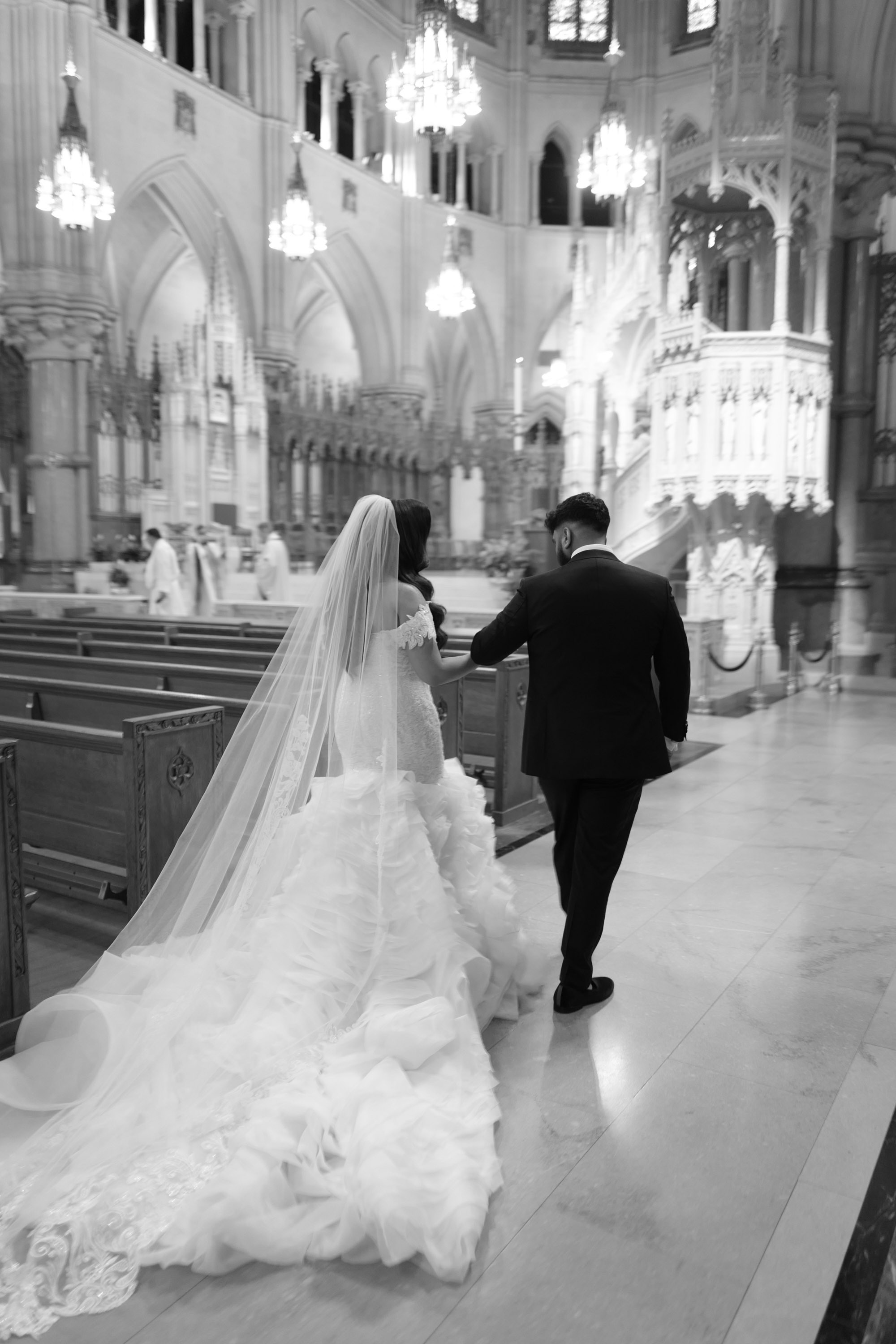 a bride and groom walking down the aisle