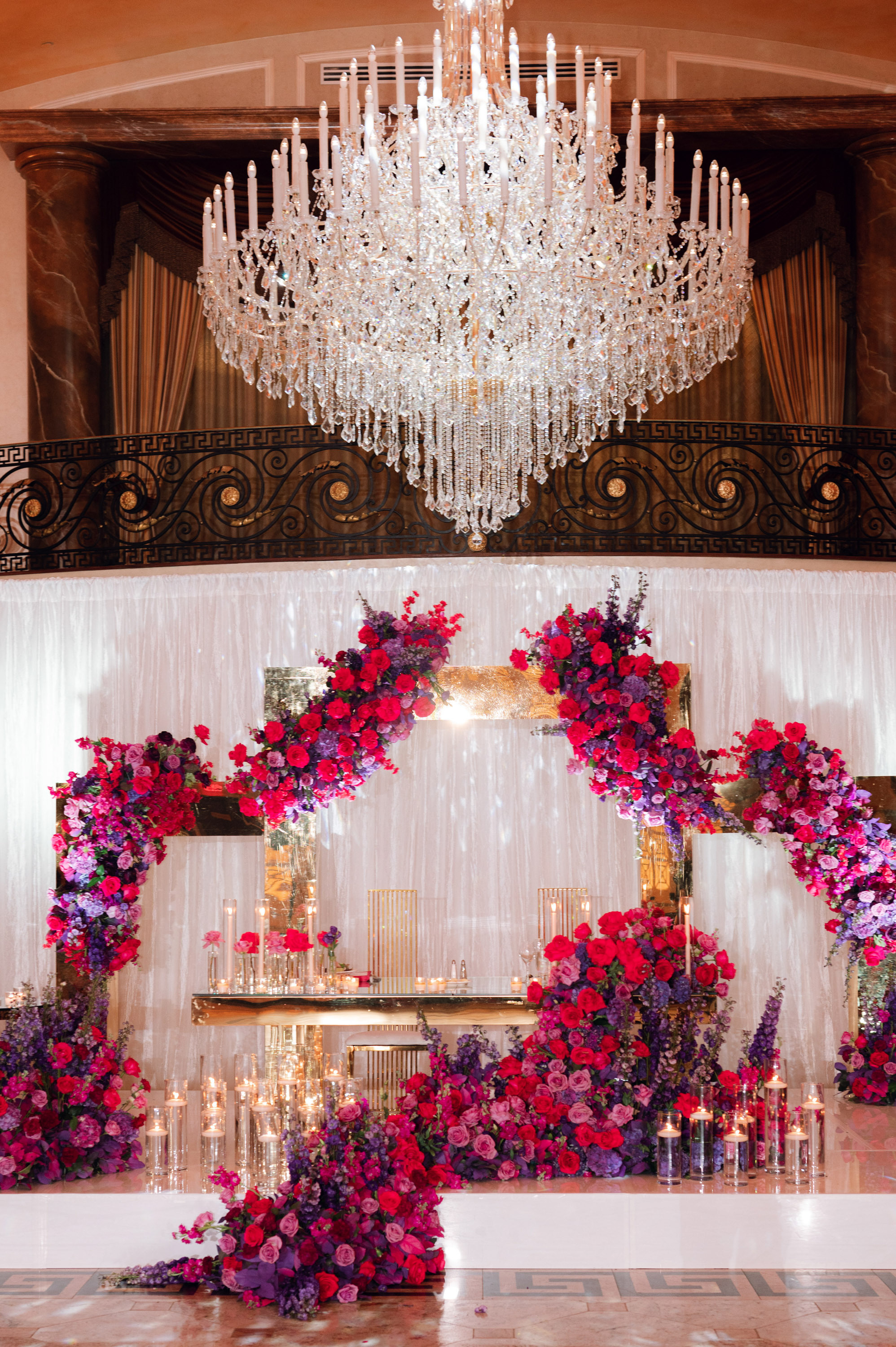 a wedding ceremony with a chandel and a floral arrangement