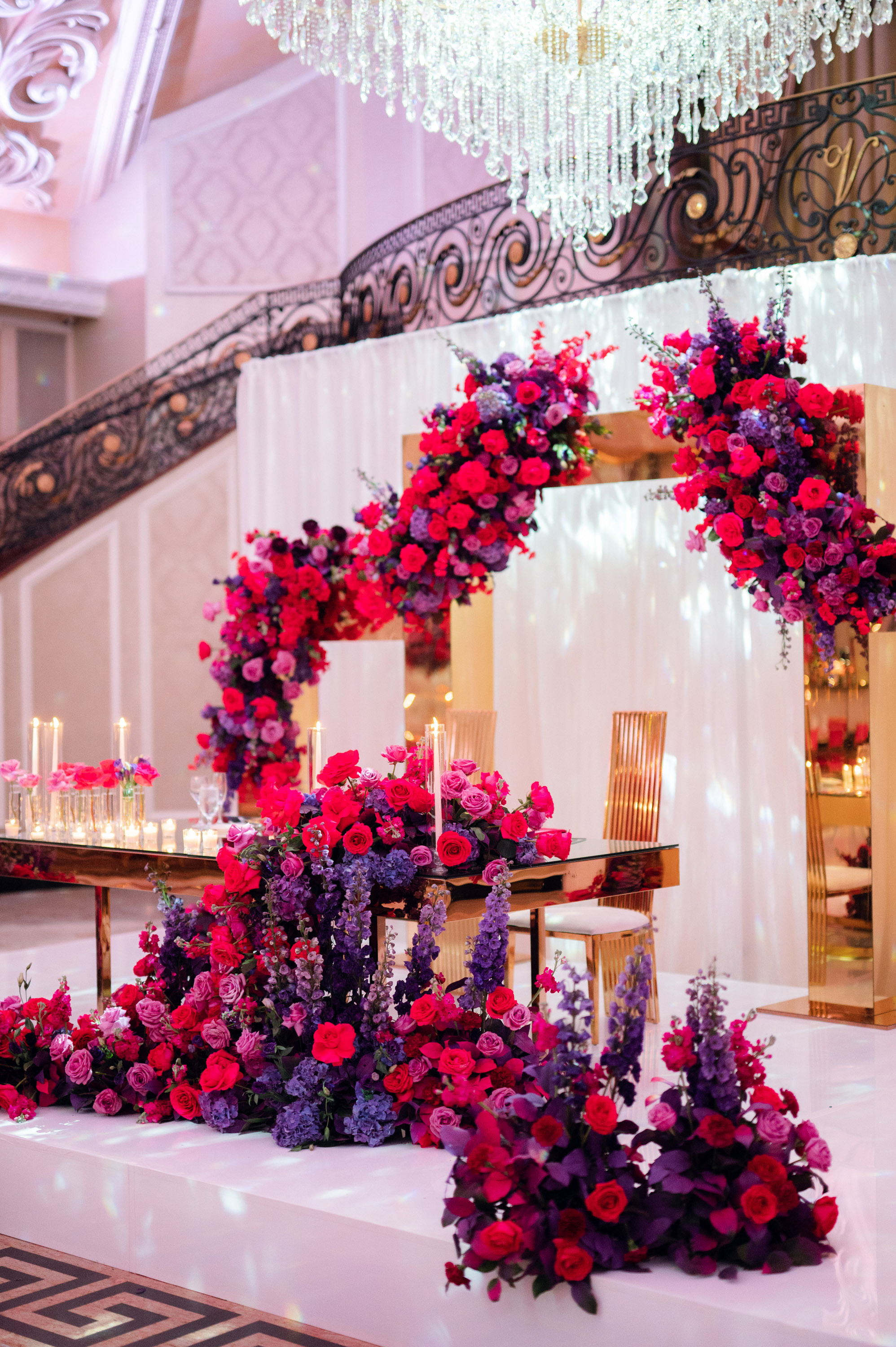 a wedding ceremony with pink flowers and candles