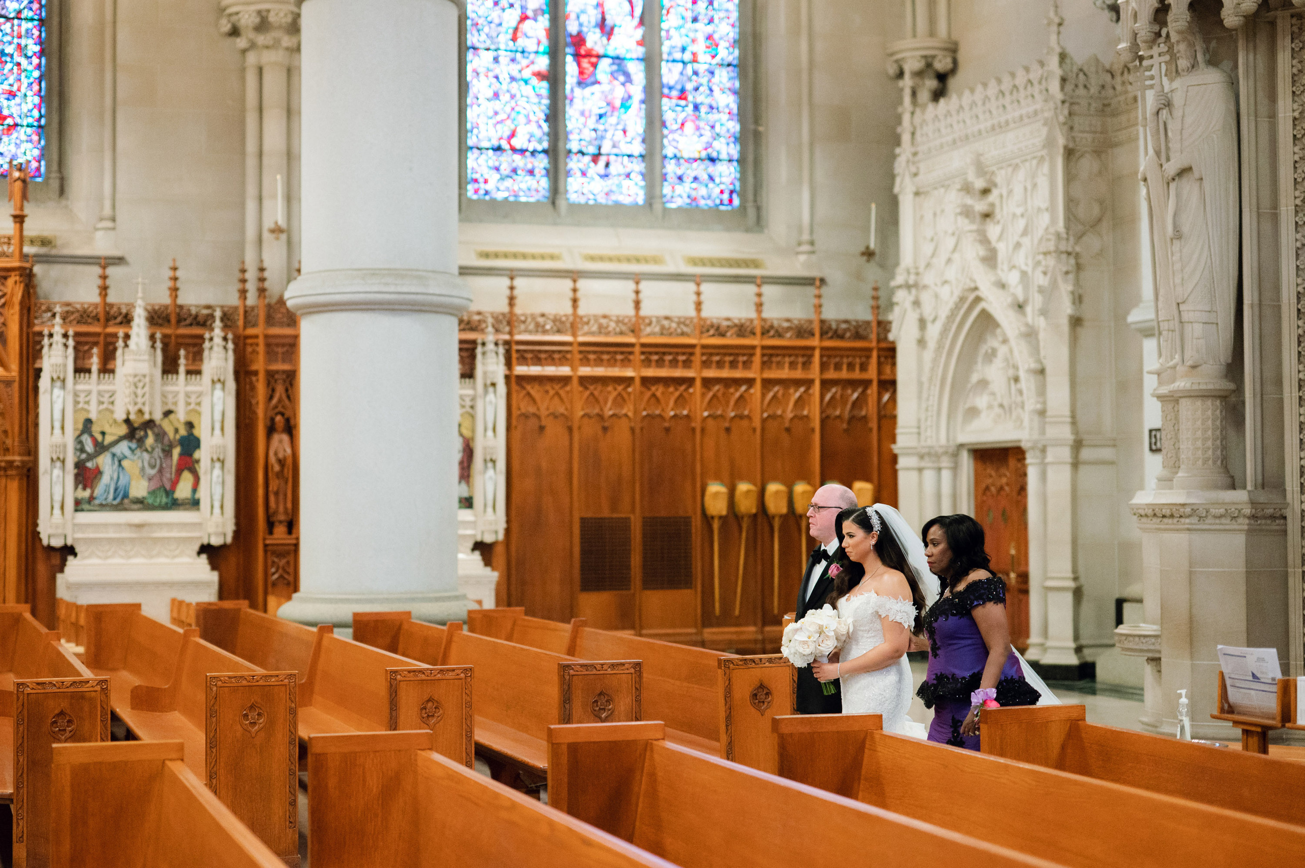 a bride and groom are walking down the aisle