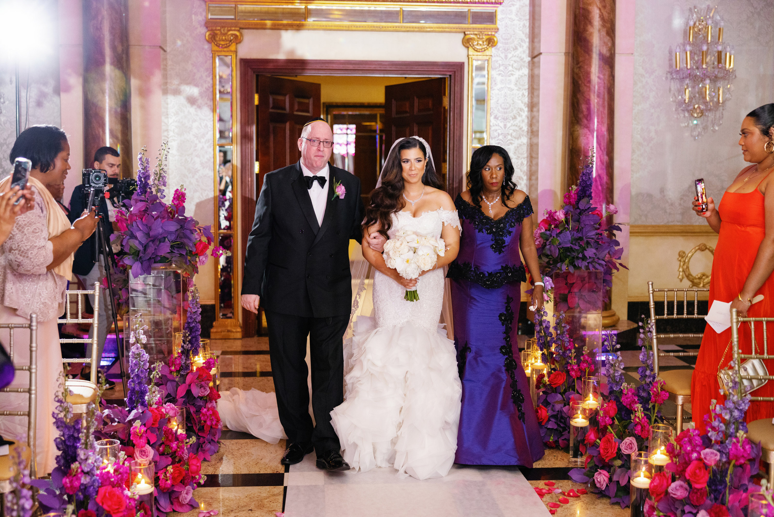 a bride and groom walking down the aisle