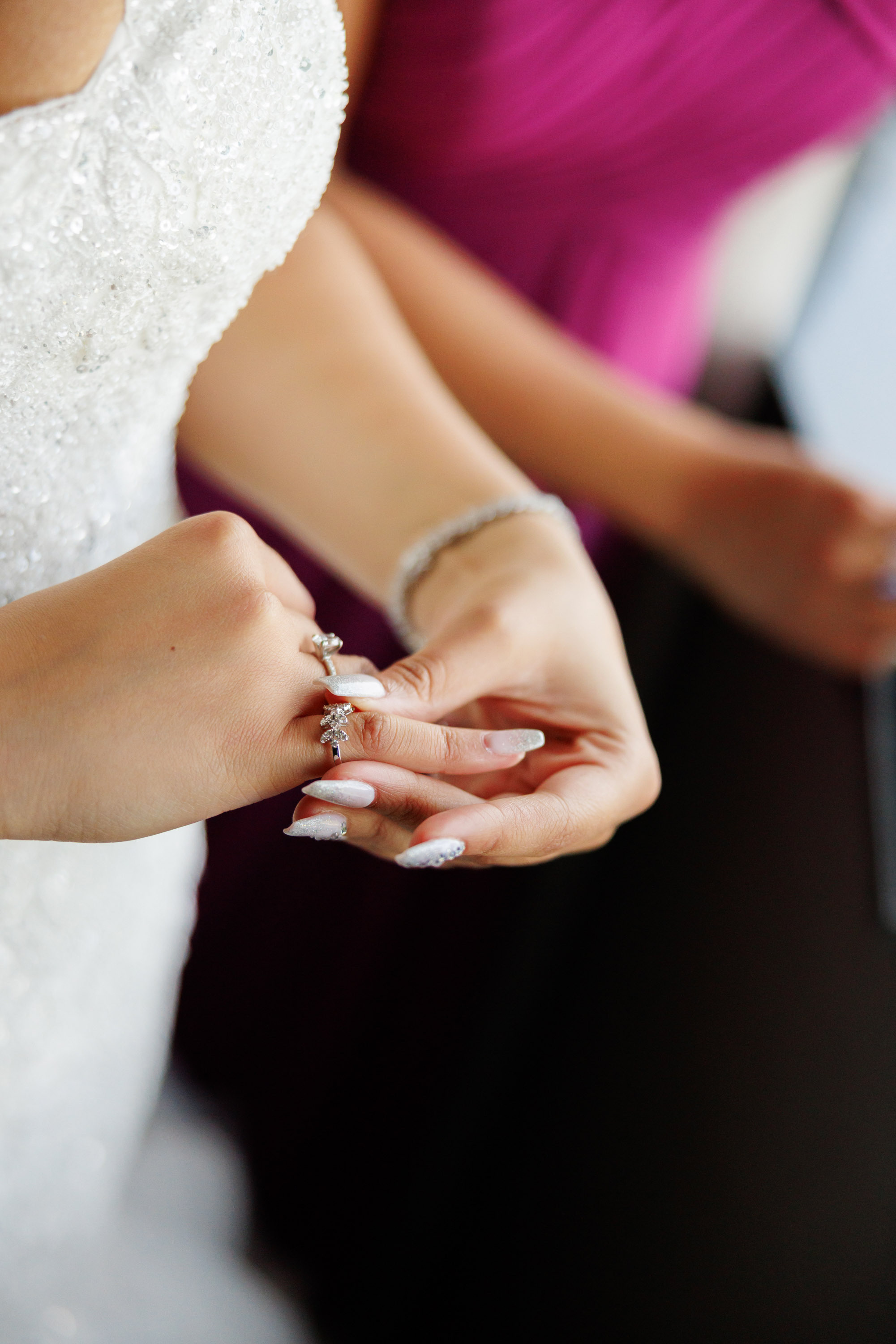 a bride holding a wedding ring in her hand