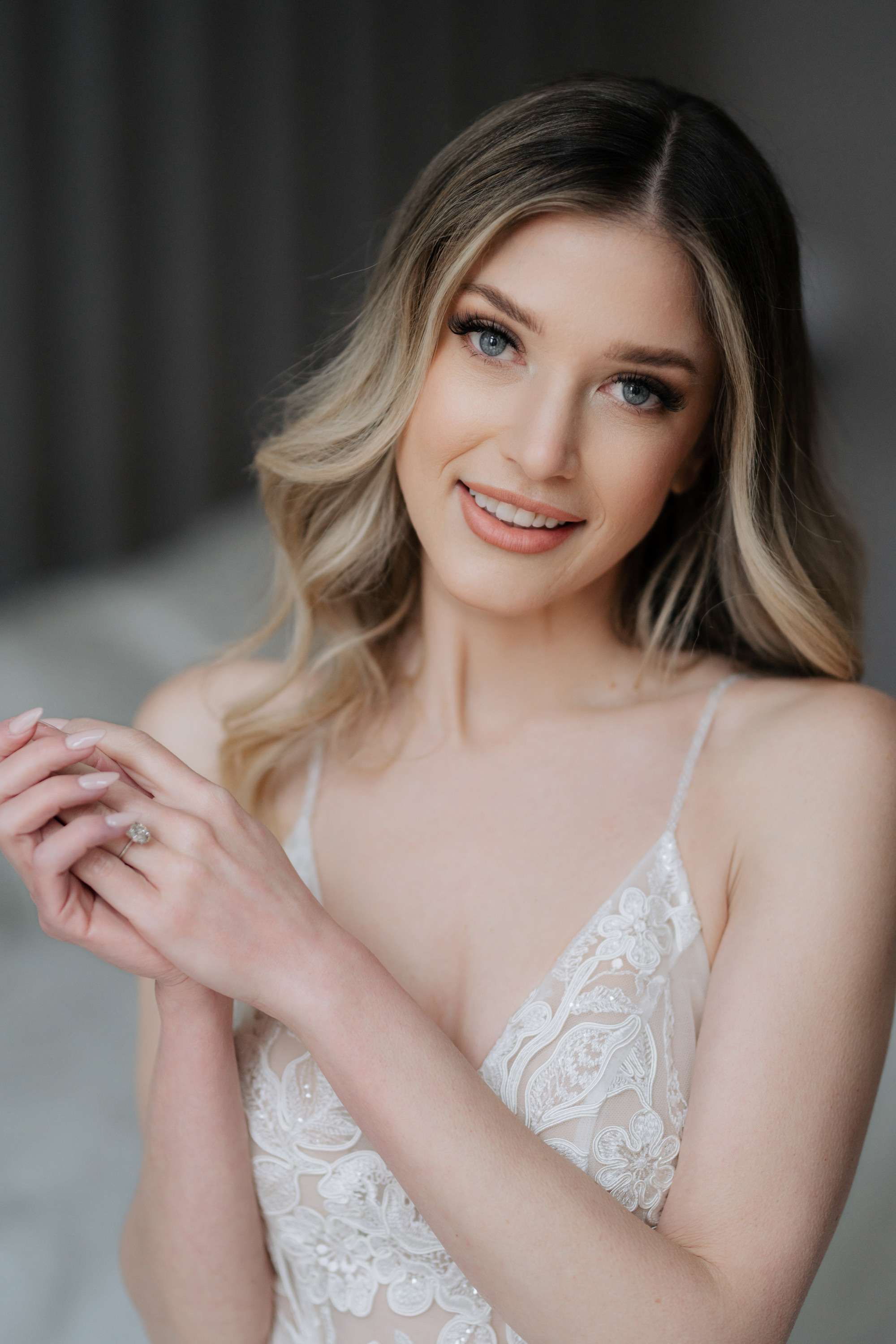 a woman in a wedding dress holding a ring