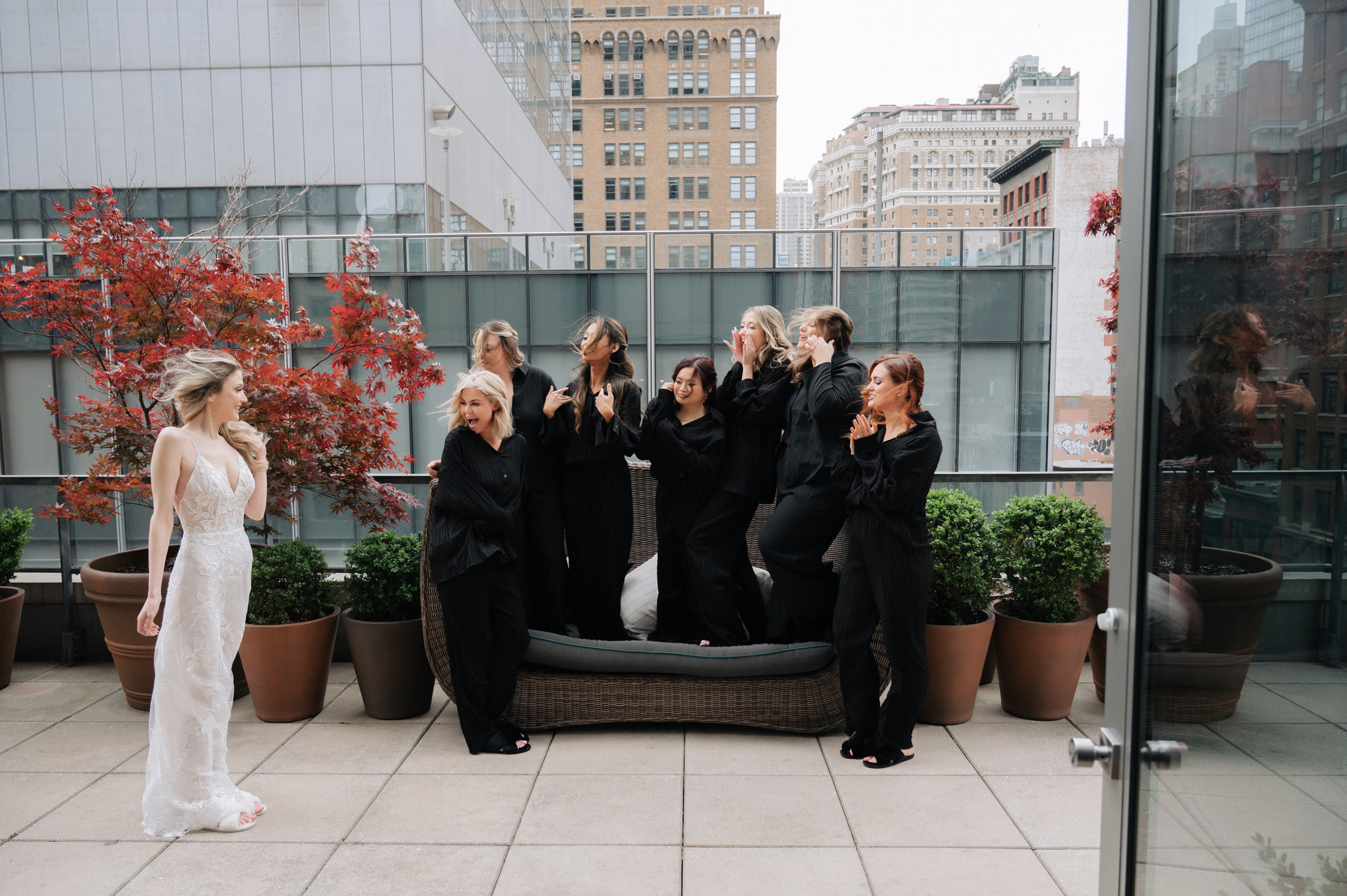 a group of women sitting on a couch on a rooftop