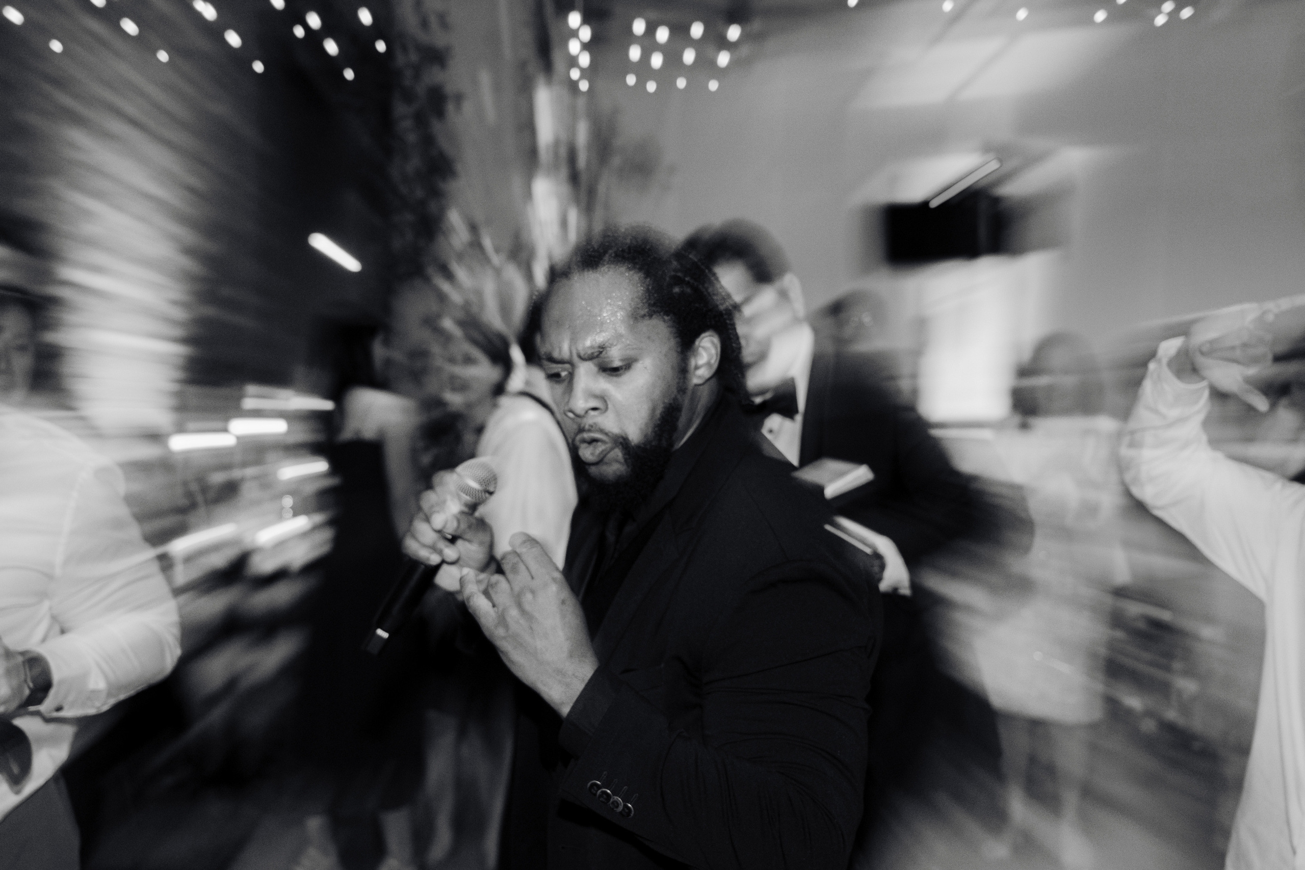 a man in a suit is dancing with other people