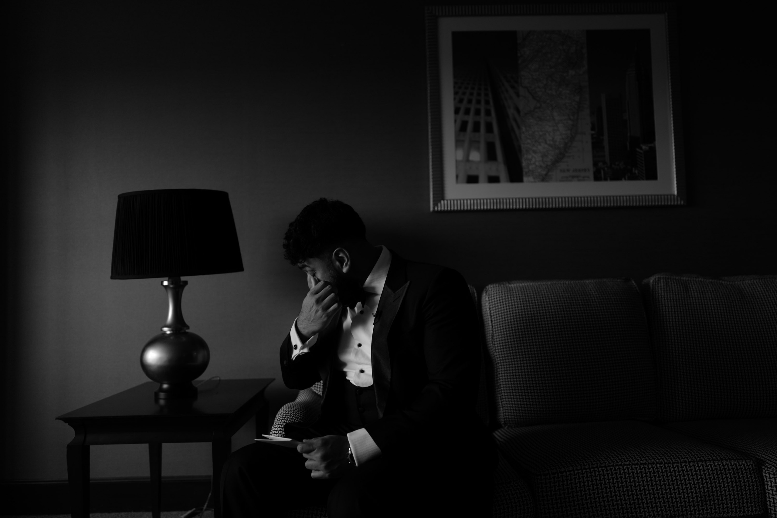 a man sitting on a couch in a dark room