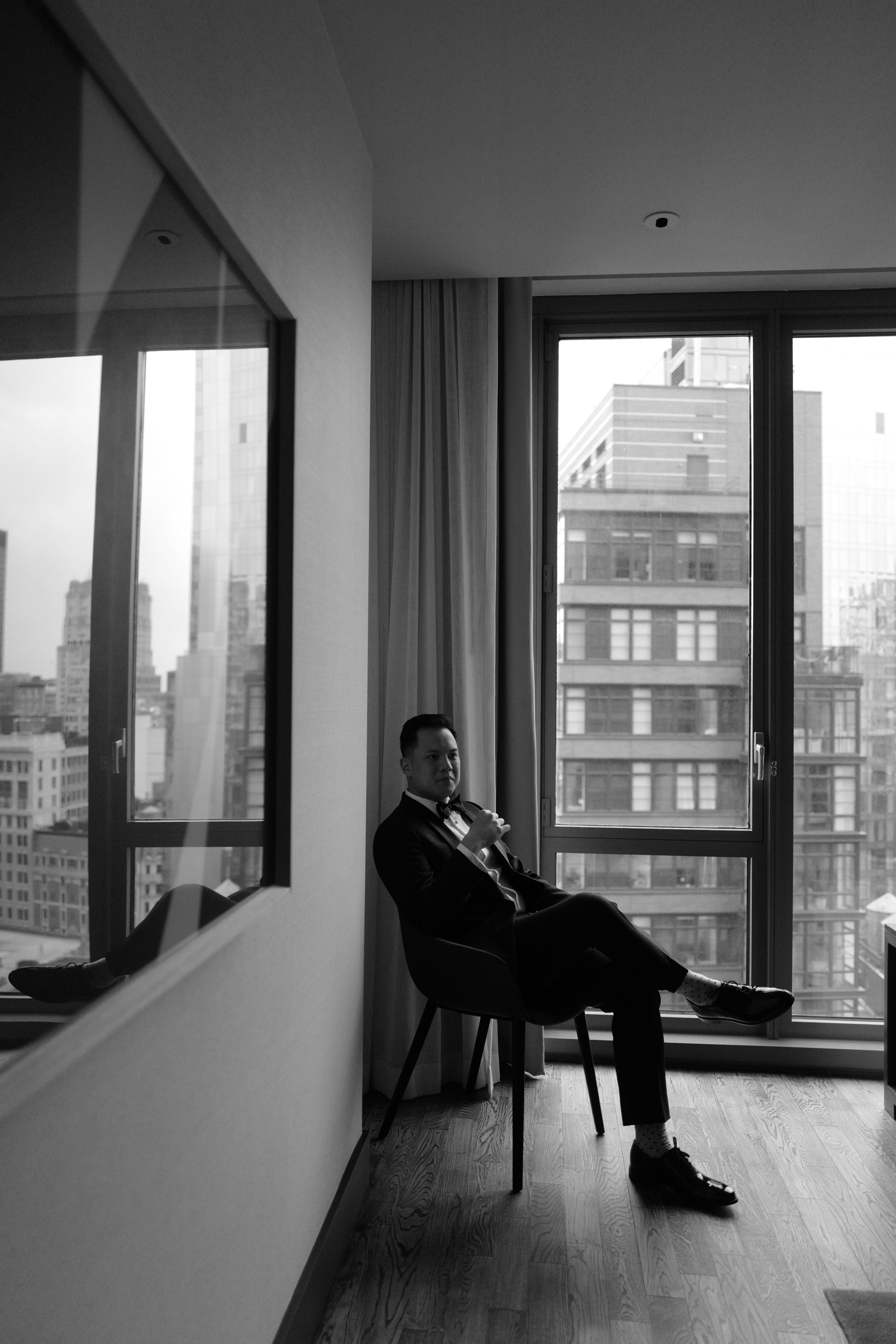 a man sitting in a chair looking out a window