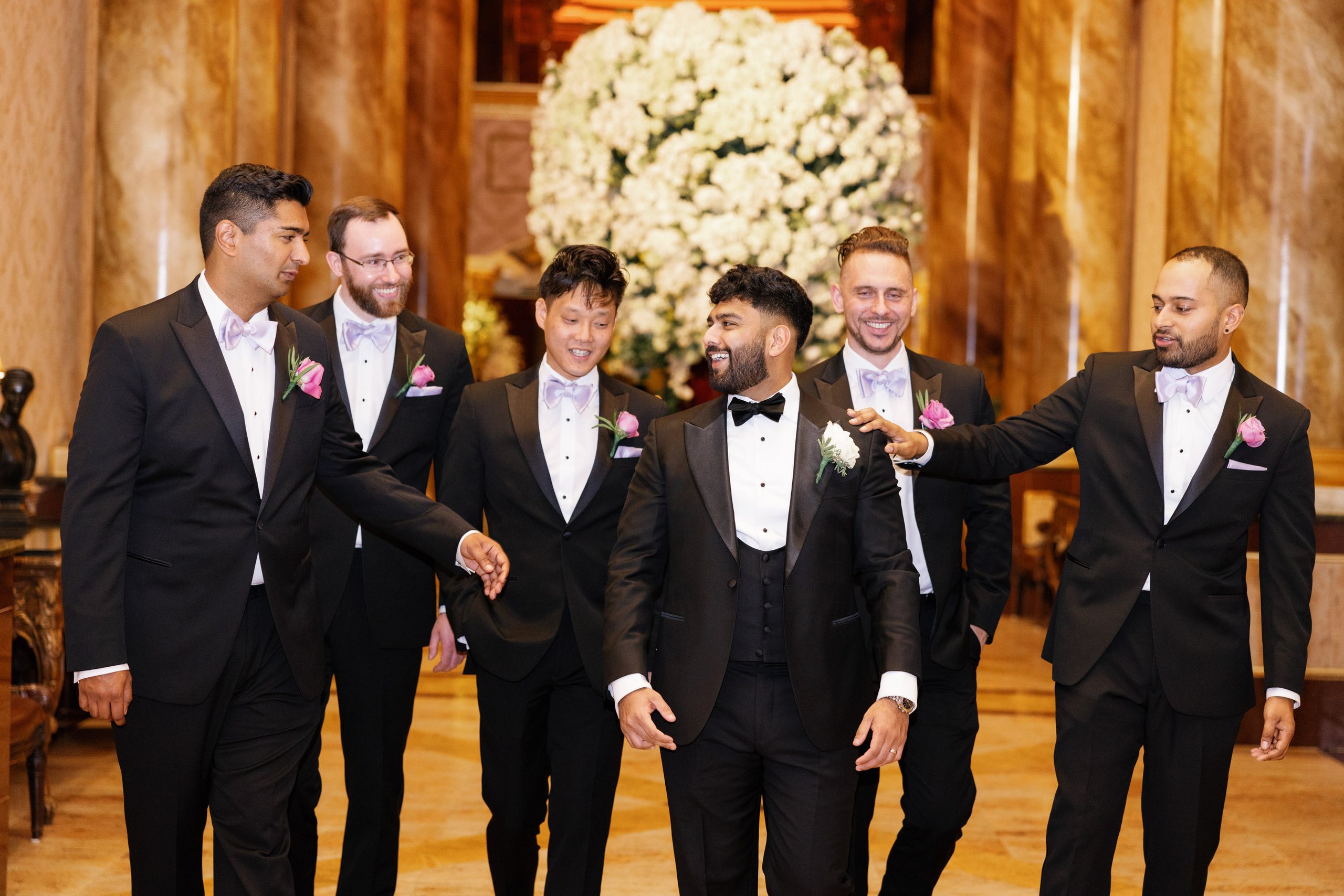 a group of men in tuxed suits standing together