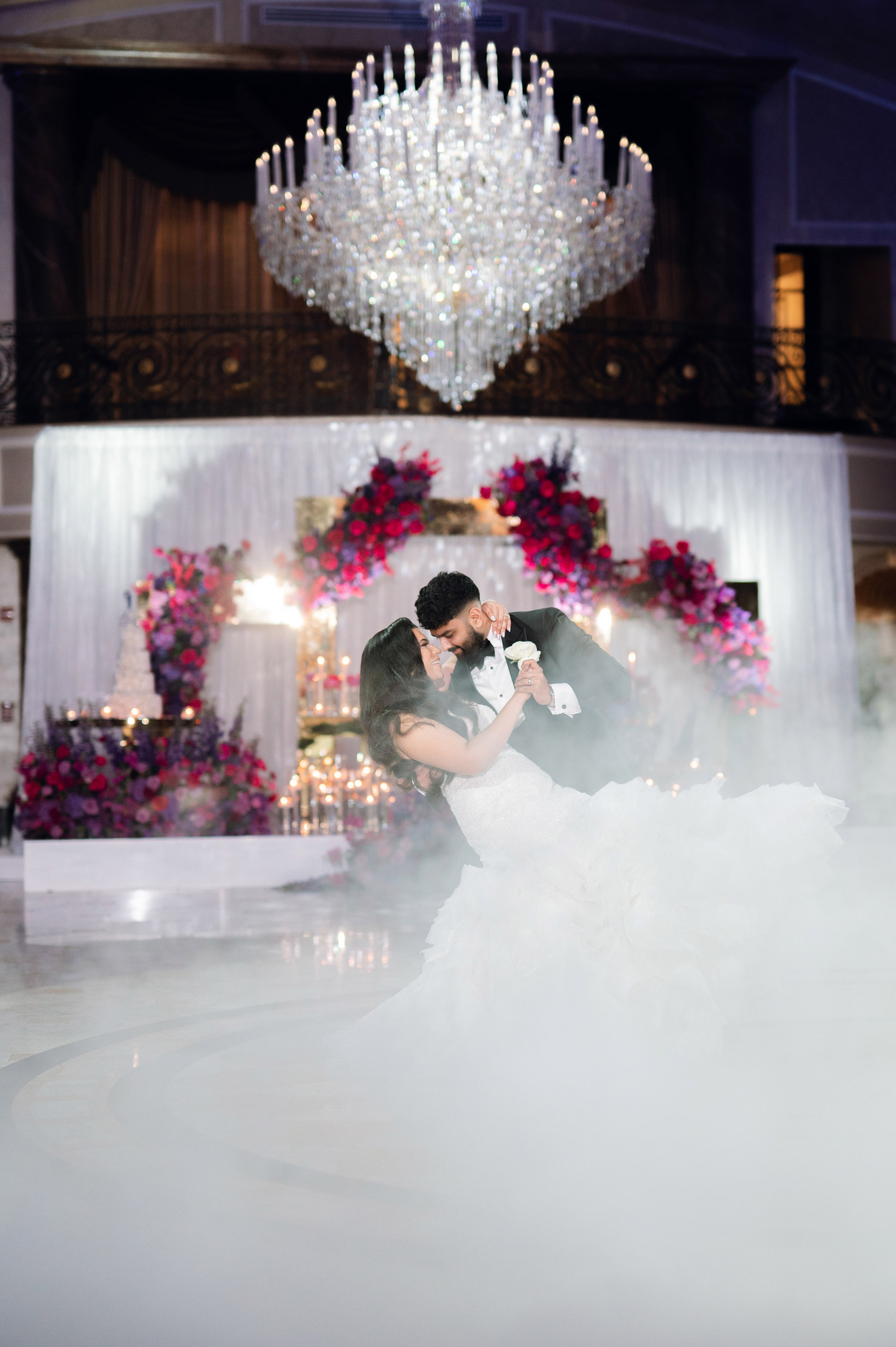 a bride and groom kissing in the middle of a cloud