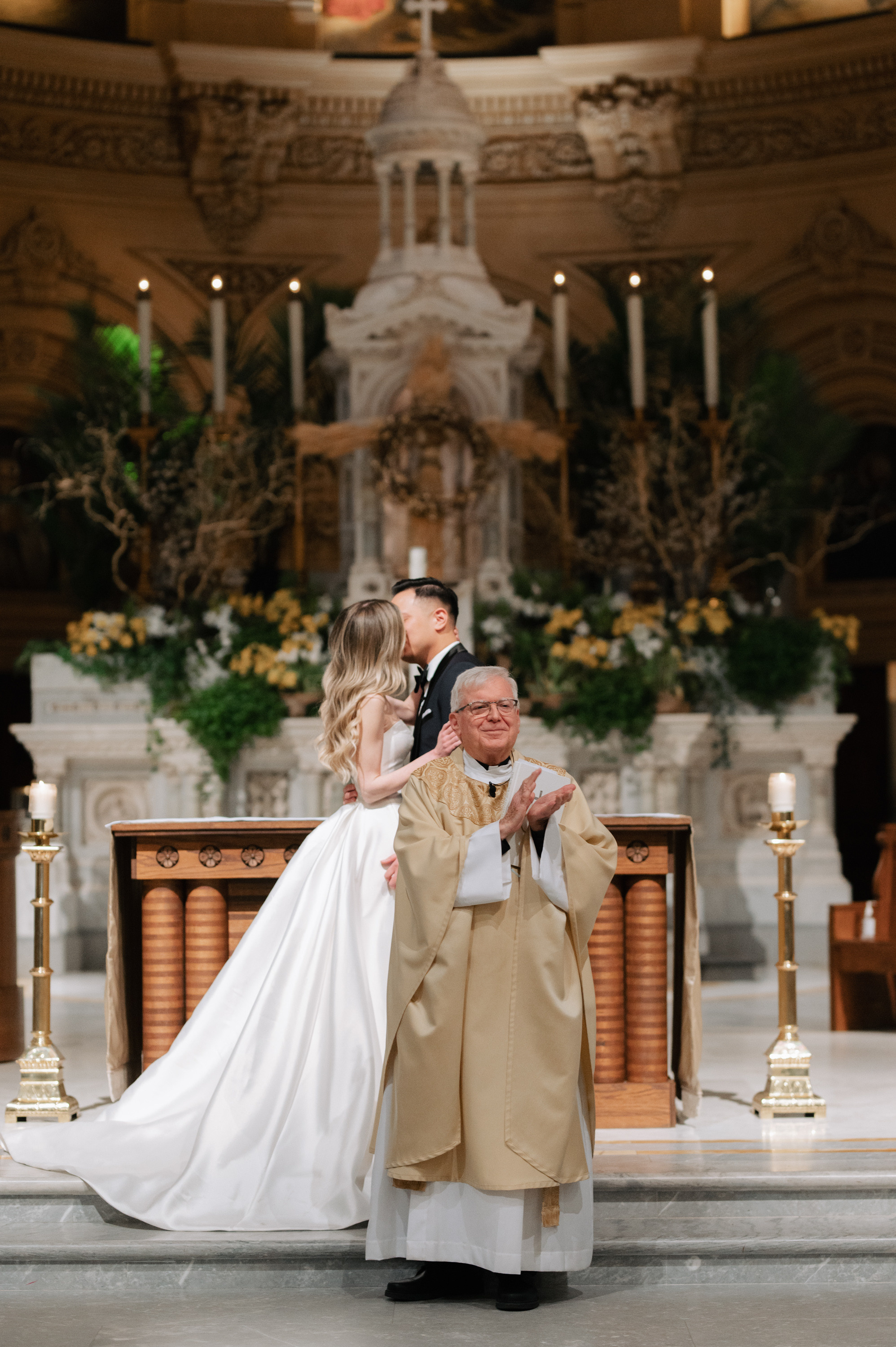 a bride and groom are standing in front of a church altar
