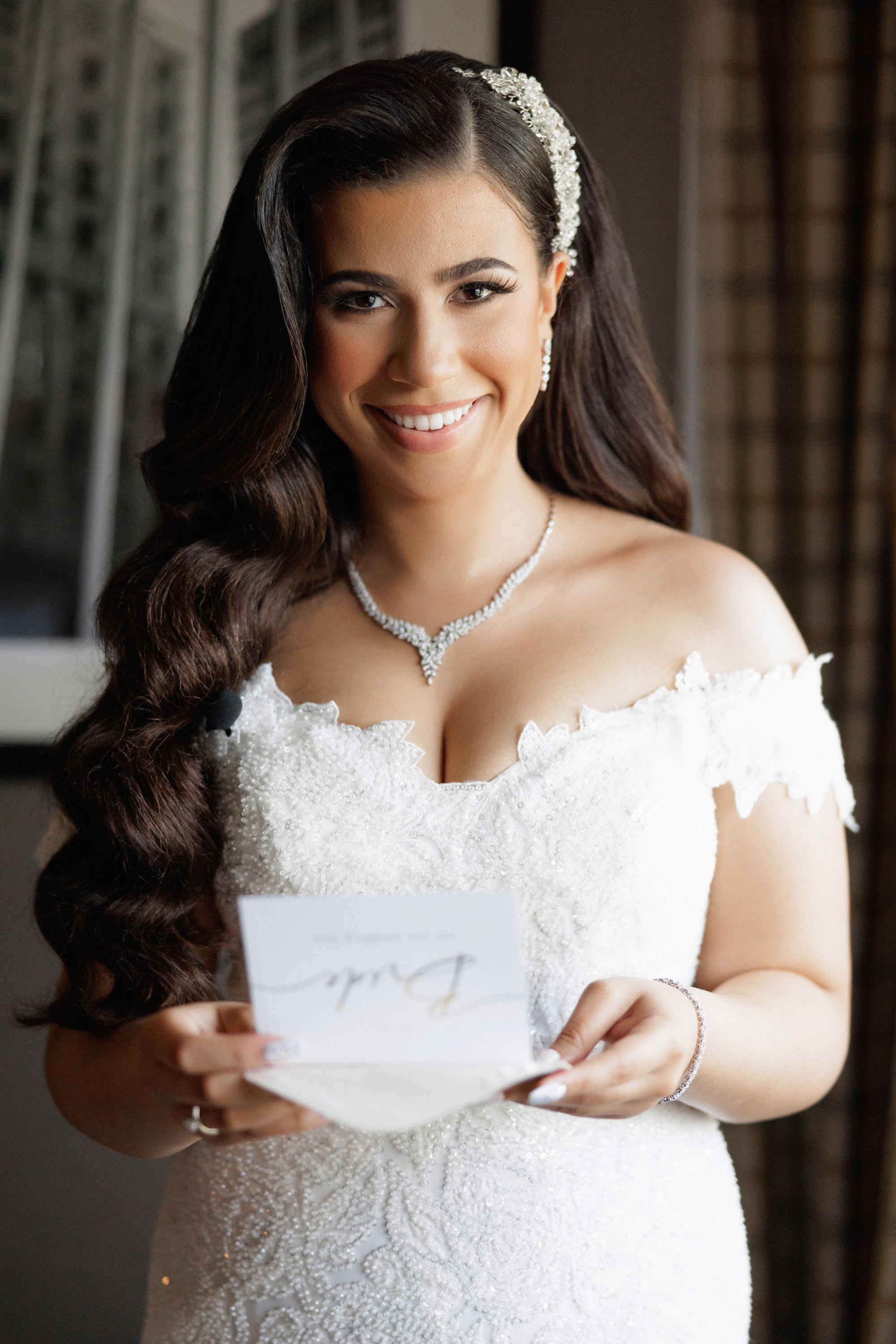 a bride holding a piece of paper in her hand
