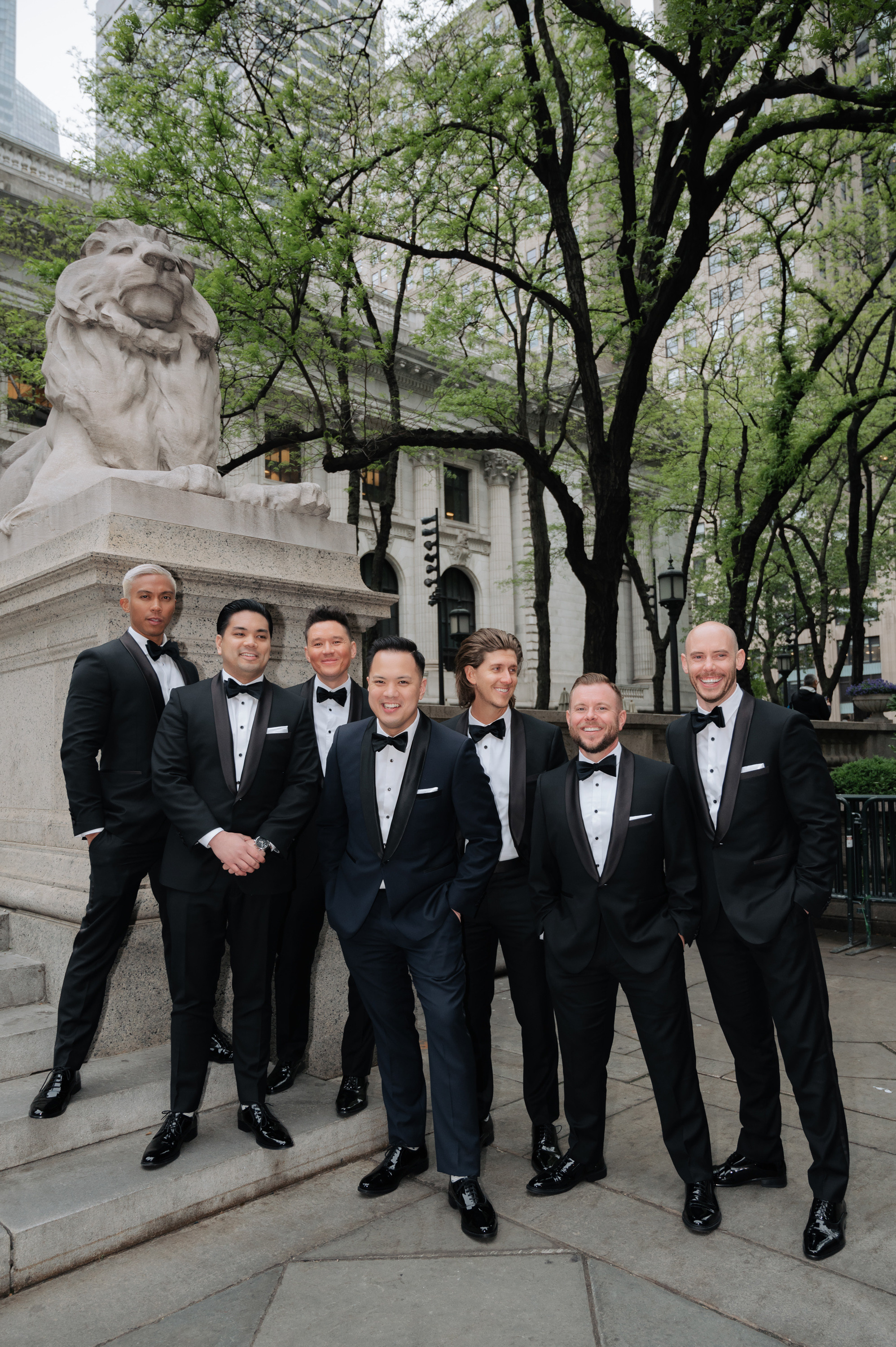 a group of men in tuxed suits posing for a picture