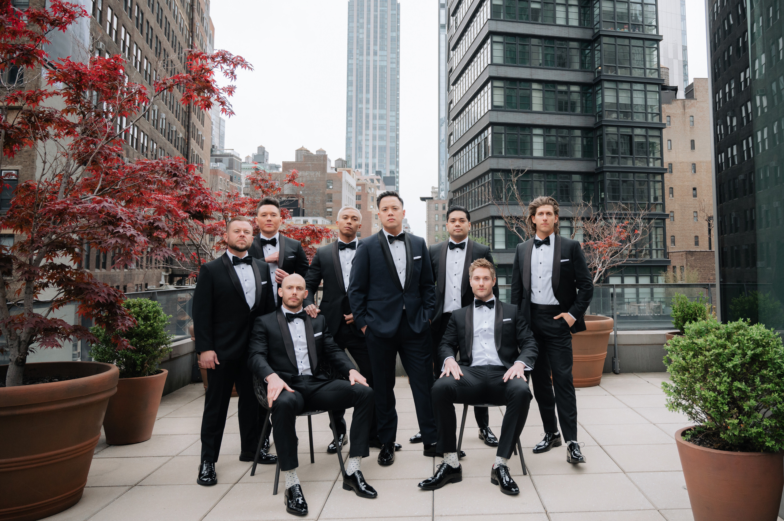 a group of men in tuxed suits posing for a picture