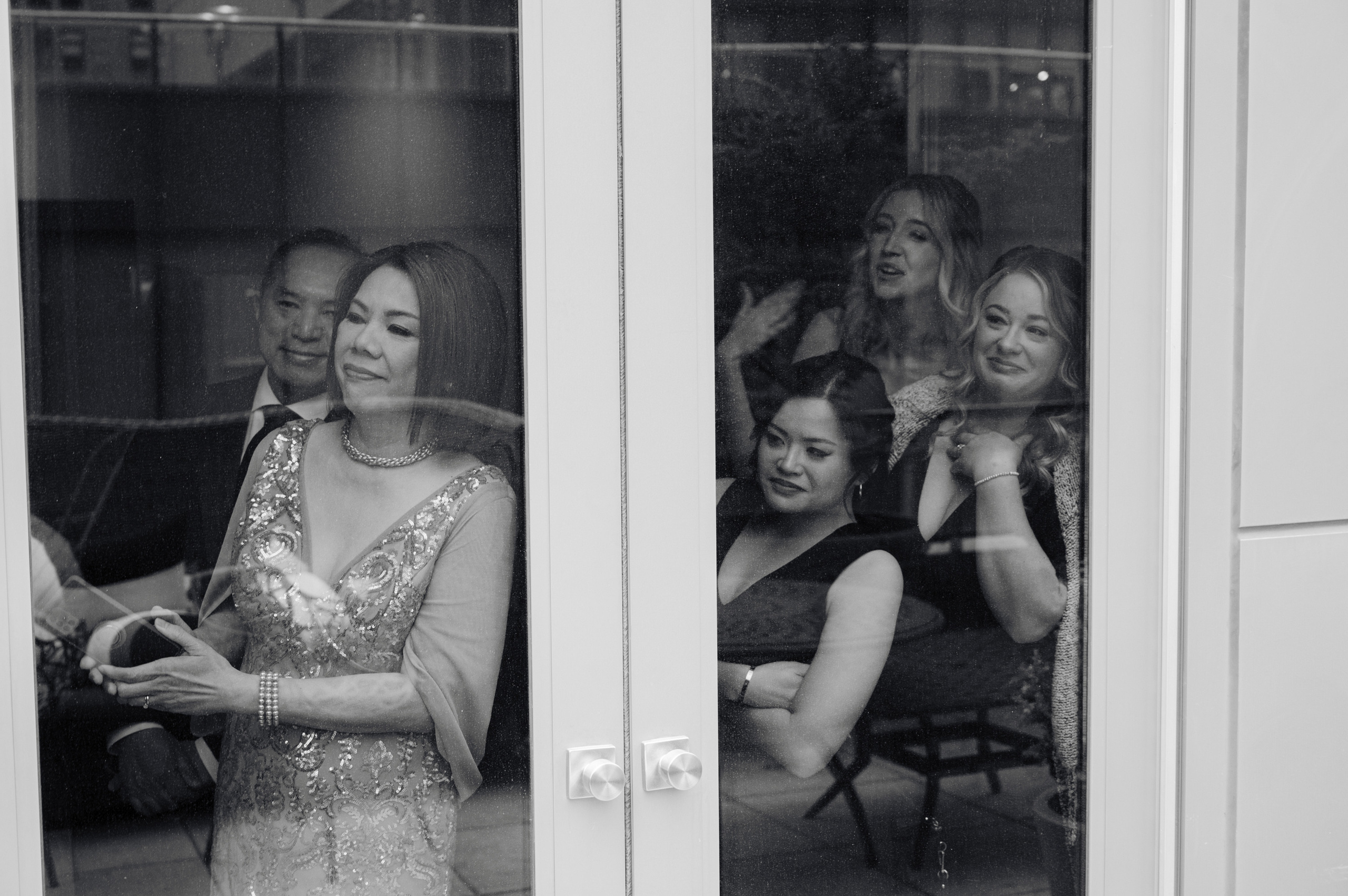 a woman in a dress is looking at her phone