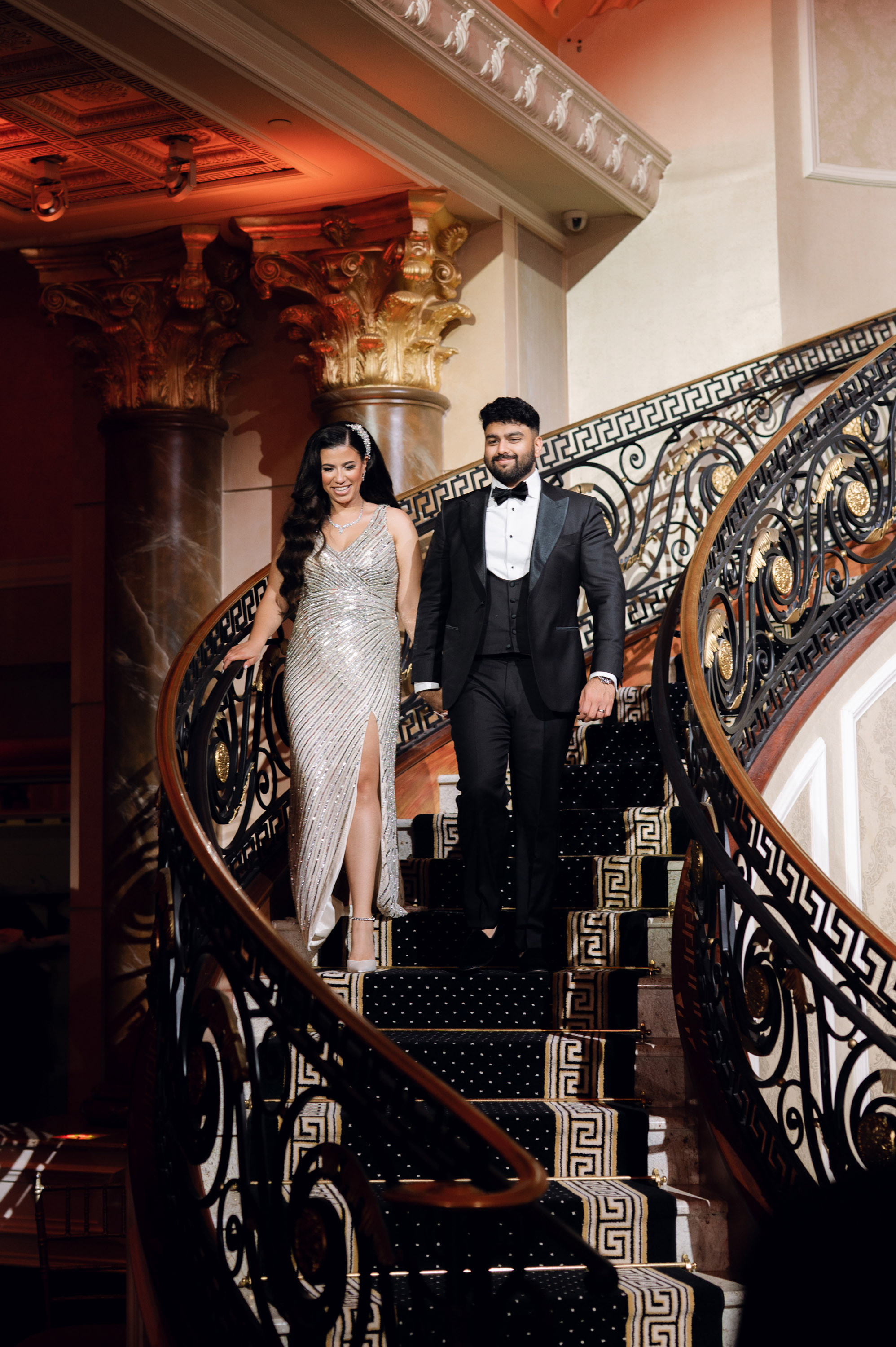 a man and woman walking down a set of stairs