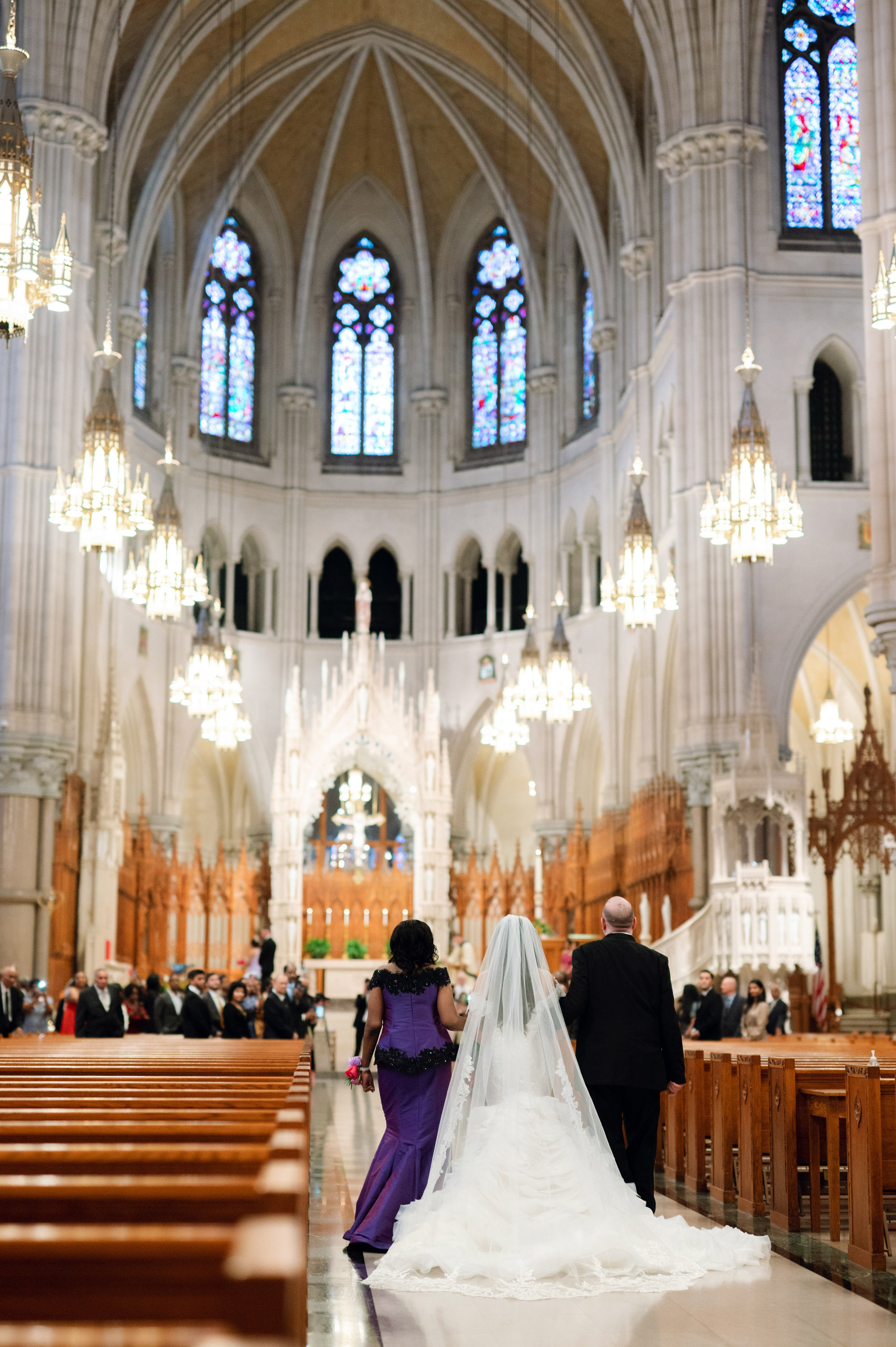 a bride and groom walking down the aisle