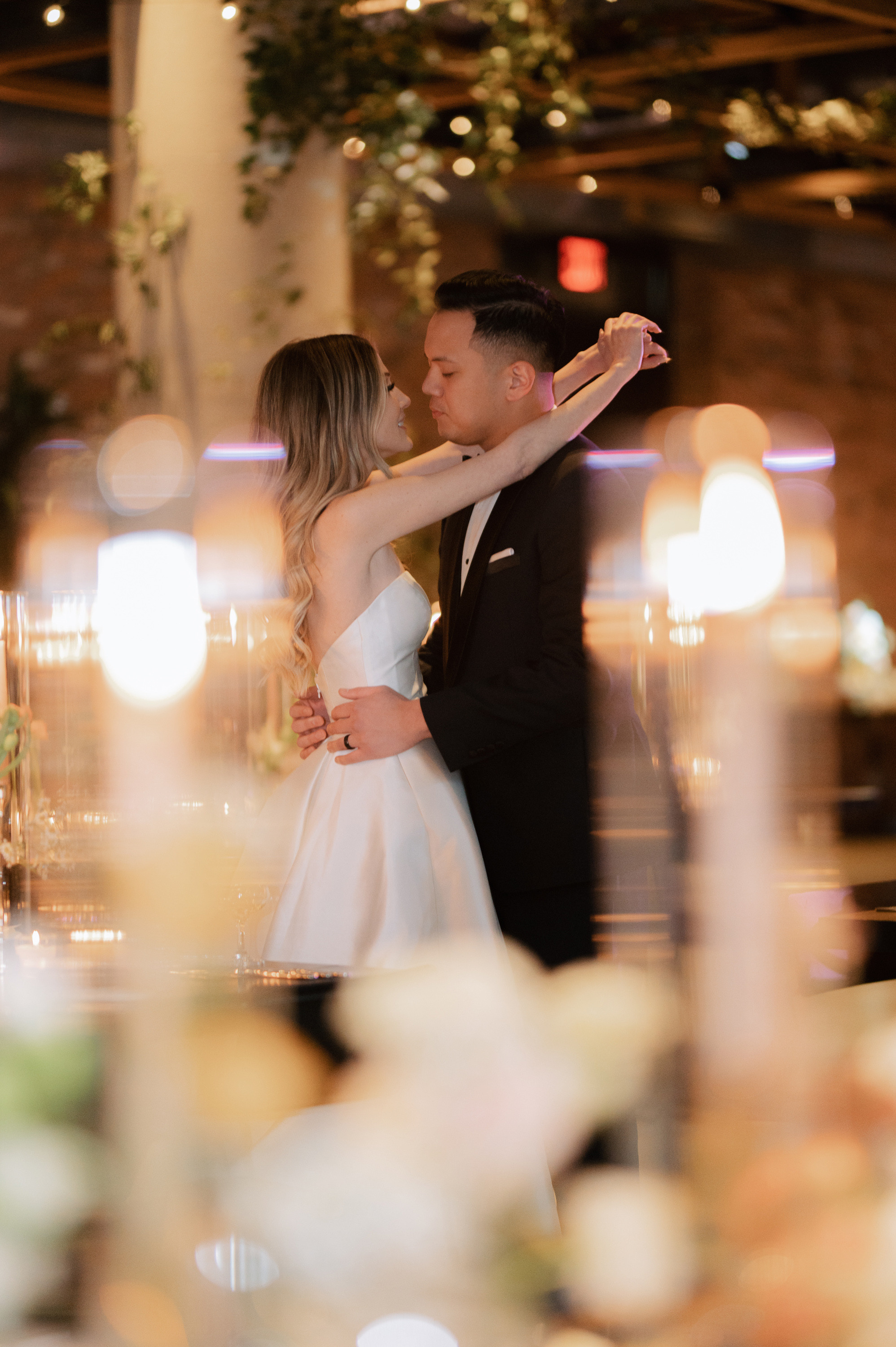 a bride and groom sharing a kiss at their wedding reception